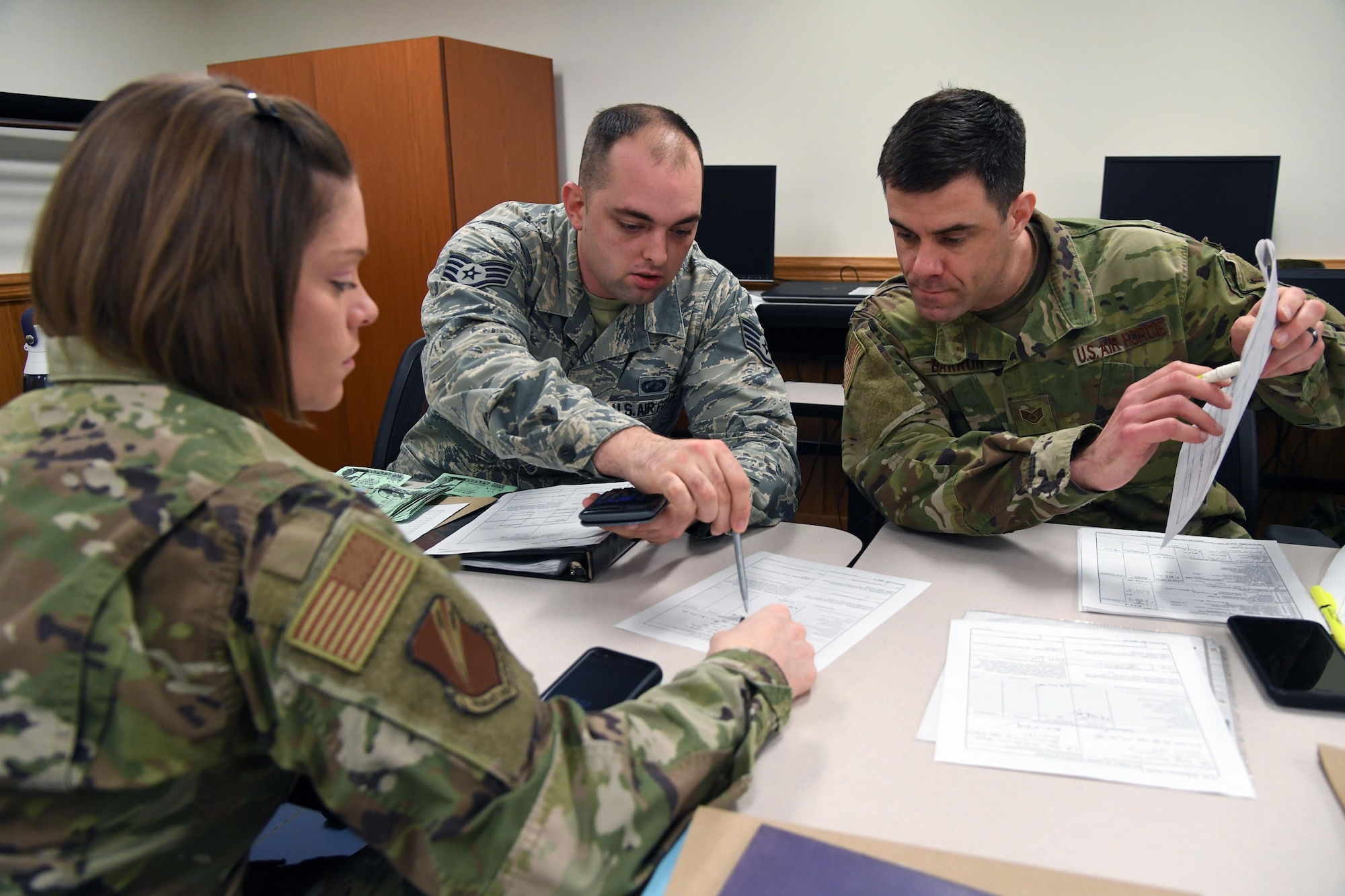 U.S. Air Force Staff Sgts. Briana Lutes, Brandon Arp and Jeffery Barron, 335th Training Squadron students, complete class work for the finance management course inside Allee Hall at Keesler Air Force Base, Mississippi, Feb. 3, 2020. This course, which graduated 220 students this past year, takes nine academic days to complete. Approximately 7,400 students go through the 335th TRS's 13 Air Force Specialty Codes each year. (U.S. Air Force photo by Kemberly Groue)