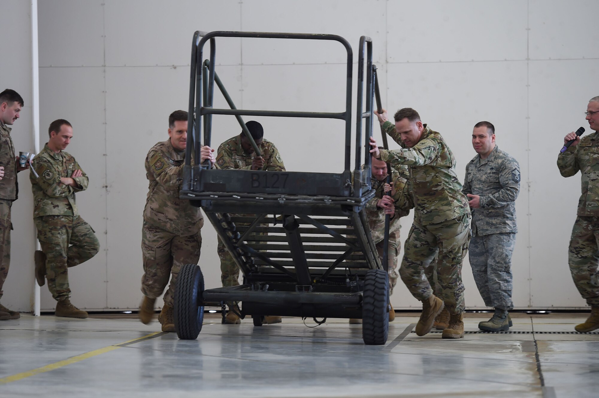 men pushing a stand