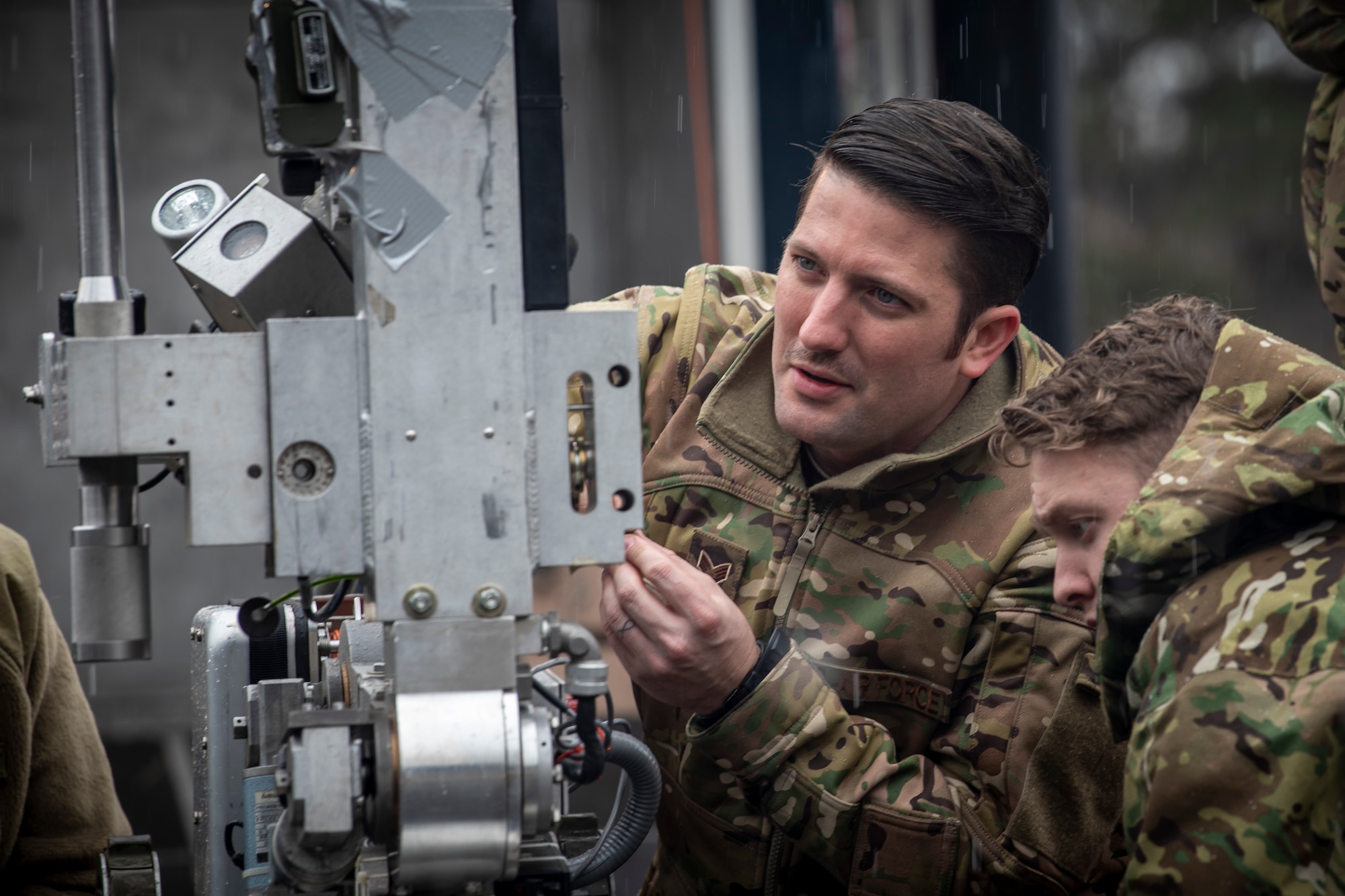 U.S. Air Force Senior Airman Tyrone Powell, left, a 35th Civil Engineer Squadron Explosive Ordnance Disposal journeyman and Airman 1st Class Derik Rosse, right, a 35th CES EOD apprentice, inspect an F6A robot at Misawa Air Base, Japan, March 3, 2020. Personnel work together with reconnaissance robots to help locate, disarm and remove improvised explosive devices. The robots enter areas inaccessible or too dangerous for people and handle potential explosives without risking any lives. (U.S. Air Force photo by Airman 1st Class China M. Shock)