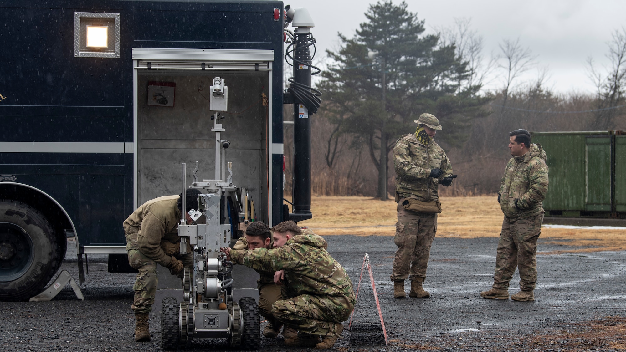 U.S. Airmen with the 35th Civil Engineer Squadron Explosive Ordnance Disposal team inspect an F6A robot at Misawa Air Base, Japan, March 3, 2020. The robot helps EOD Airmen dispose of potential explosives without putting human life at risk. (U.S. Air Force photo by Airman 1st Class China M. Shock)