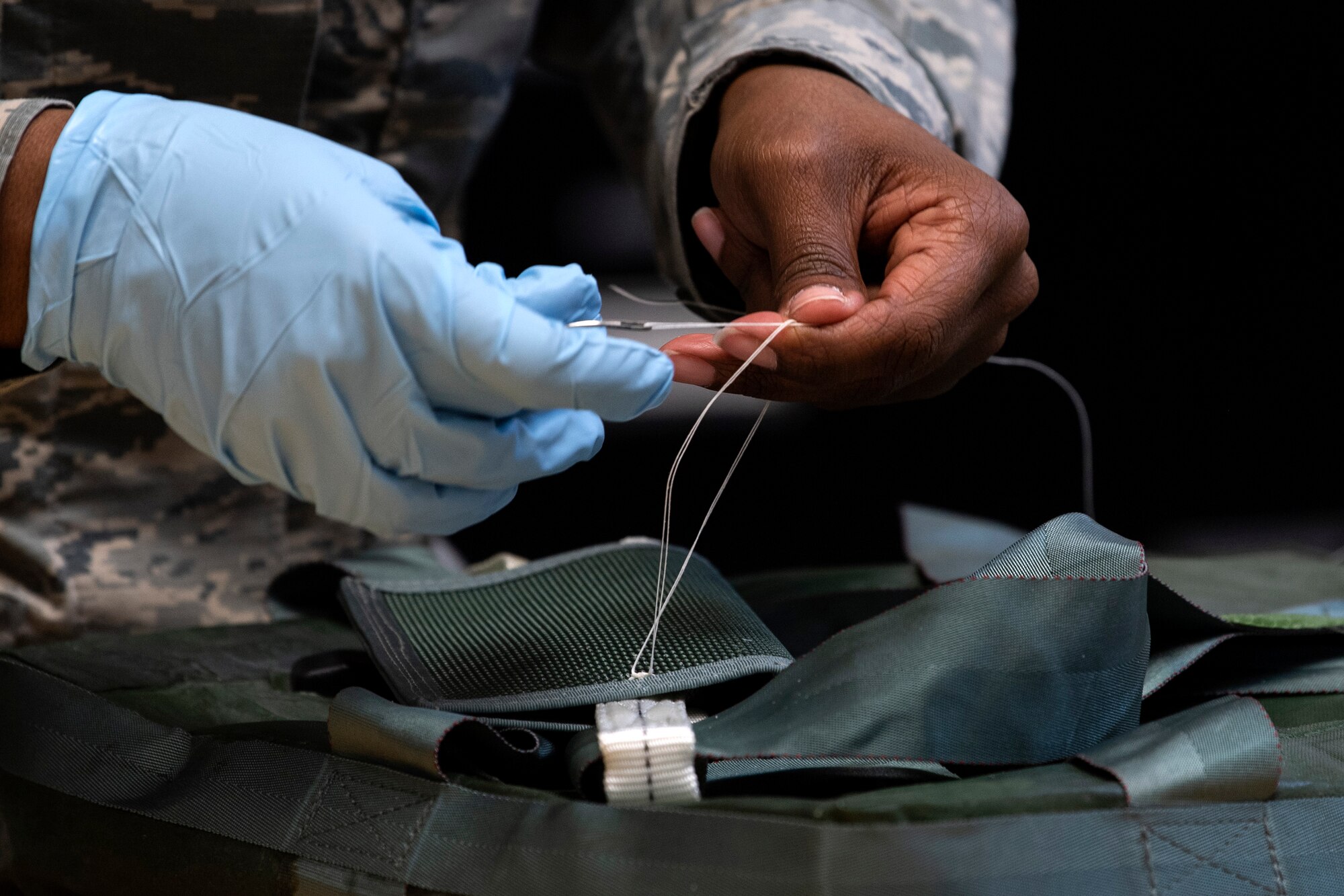 U.S. Air Force Senior Airman Roshelle Styles, 52nd Operations Support Squadron Aircrew Flight Equipment journeyman, sews tacking on an aircrew survival kit at Spangdahlem Air Base, Germany, March 4, 2020. Spangdahlem AFE Airmen prepare, inspect, and fix all the gear 480th Fighter Squadron pilots require. (U.S. Air Force photo by Senior Airman Valerie R. Seelye)