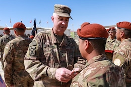 Maj. Gen. John P. Sullivan, Commanding general of the 1st Theater Sustainment Command presents a Soldier from the 1st Battalion, 294th Infantry Regiment, Guam National Guard, with the MFO Medals during the Transfer of authority ceremony on South Camp, in Sharm el-Sheikh, Egypt, March 8, 2020. For the past 9 months, the 1-294th have served as the 66th rotational U.S. Army unit in support of the MFO peacekeeping mission.