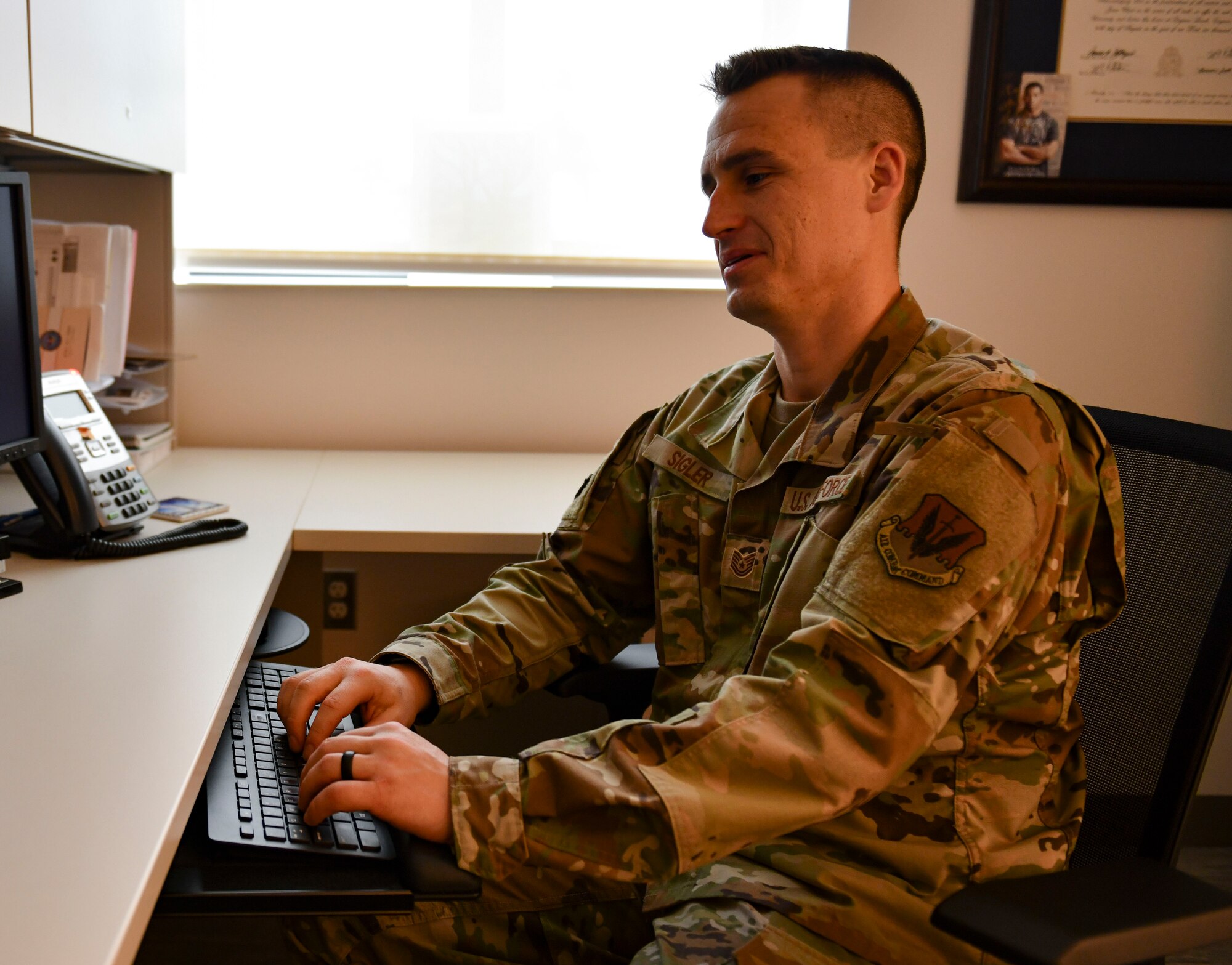 U.S. Air Force Tech. Sgt. James Sigler, 325th Operational Medical Readiness Squadron mental health flight chief, types on a computer at Tyndall Air Force Base, Florida, March 4, 2020. Sigler is in charge of the mental health clinic's daily operations and makes sure the patients get the care they need. (U.S. Air Force photo by Senior Airman Stefan Alvarez)