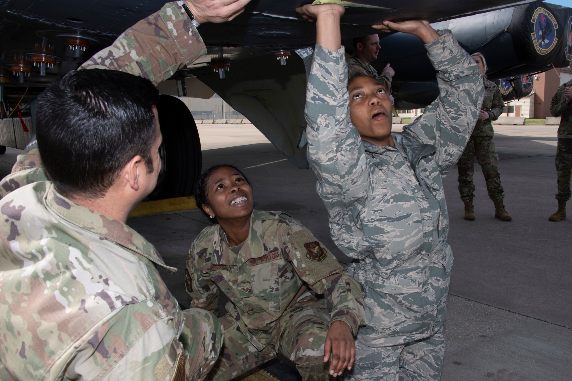 Photo of Airmen closing hatch on B-52.