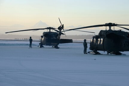 Crew chiefs for the NHARNG's 1/169th General Support Aviation Batallion, stand by their Black Hawks as they try to warm in the sub-zero temperatures at Eielson Air Base, Alaska on Feb. 26.