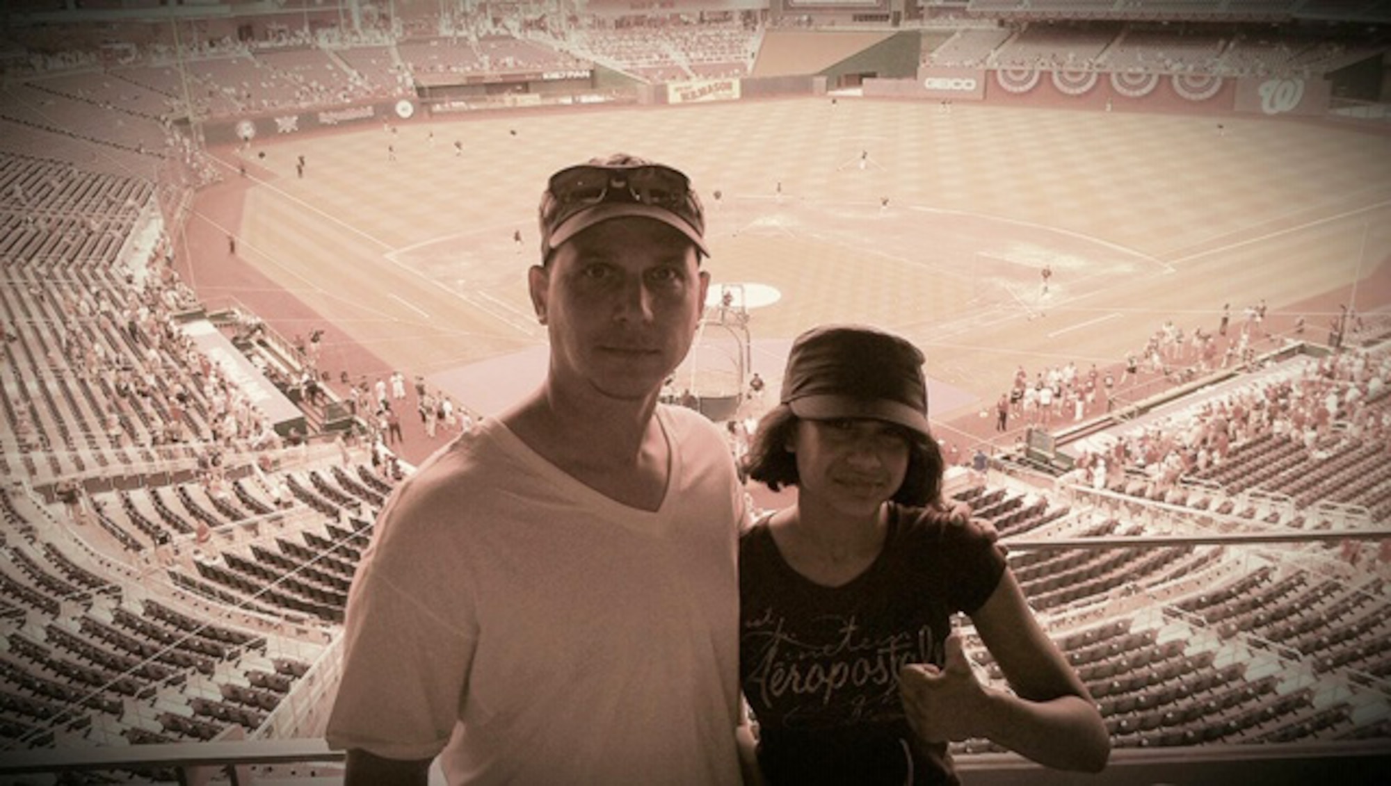 Then-Senior Master Sgt. Thomas Daniels and his daughter, Dakotah Daniels, 14, pose for a photo during a baseball game at Nationals Park in Washington D.C., in July 2012. (Courtesy photo)