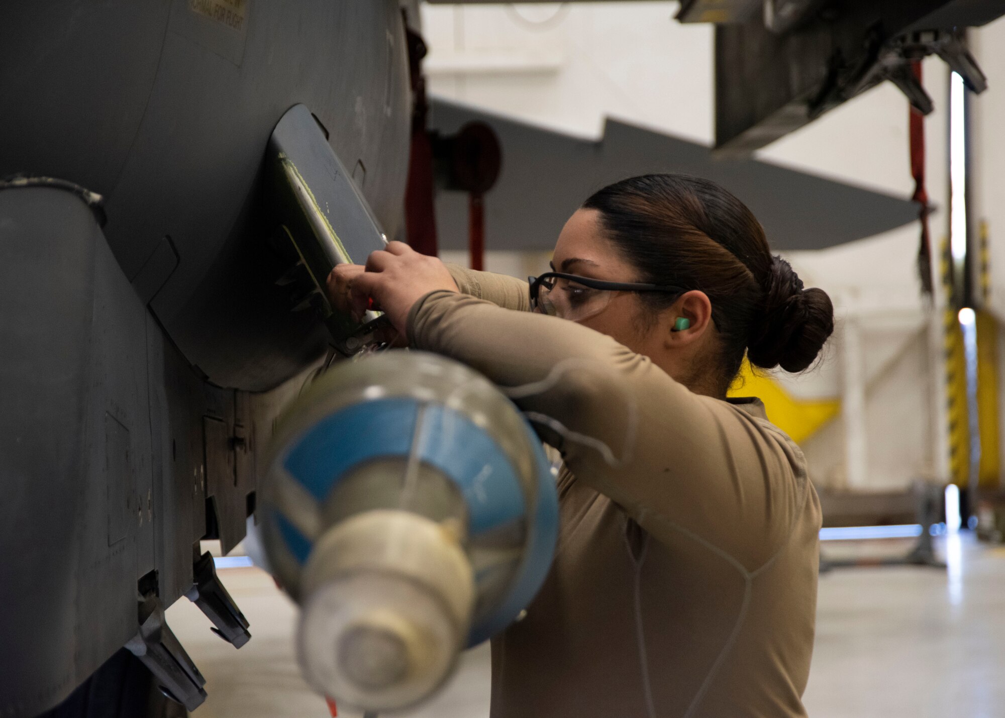 U.S. Air Force Senior Airmen Arlene Castro-Lopez, 391st Fighter Squadron load crew member, secures a guided bomb unit on the F-15E Strike Eagle during the Annual Load Crew Competition, Feb. 25, 2020, at Mountain Home Air Force Base, Idaho. Lopez is part of a three-man load crew that is competing in the Annual Load Crew Competition. (U.S. Air Force photo by Airman 1st Class Akeem K. Campbell)