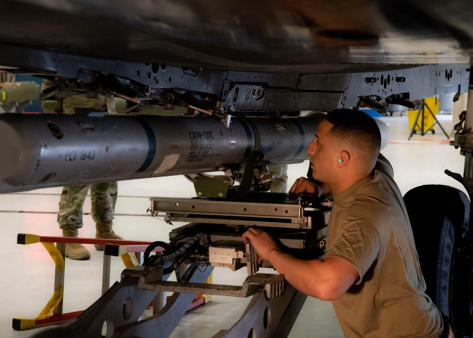 U.S. Air Force Staff Sgt. Elmehdi Berrissoul, 391st Fighter Squadron lead crew team chief, monitors the process of securing an Air Intercept Missile on the F-15E Strike Eagle during the Annual Load Crew Competition, Feb. 25, 2020, at Mountain Home Air Force Base, Idaho. The Annual Load Crew Competition tests the knowledge and skills of the competing Airmen. (U.S. Air Force photo by Airman 1st Class Akeem K. Campbell)