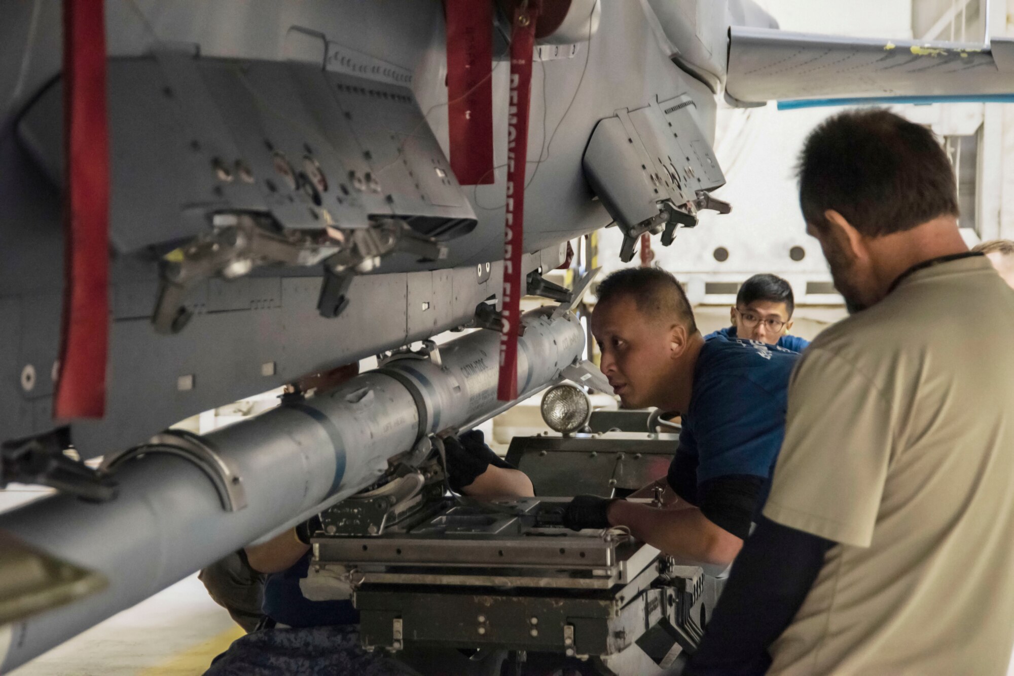 Republic of Singapore air force ME2 Yong Chin Bay, 428th Fighter Squadron load crew team chief, closely directs ME1 Nigel Goh, 428th FS weapons troop, on securing an Air Intercept Missile to the F-15SG Strike Eagle during the Annual Load Crew Competition, Feb. 25, 2020, at Mountain Home Air Force Base, Idaho. The Annual Load Crew Competition tests the knowledge and skills of the competing Airmen. (U.S. Air Force photo by Airman 1st Class Akeem K. Campbell)
