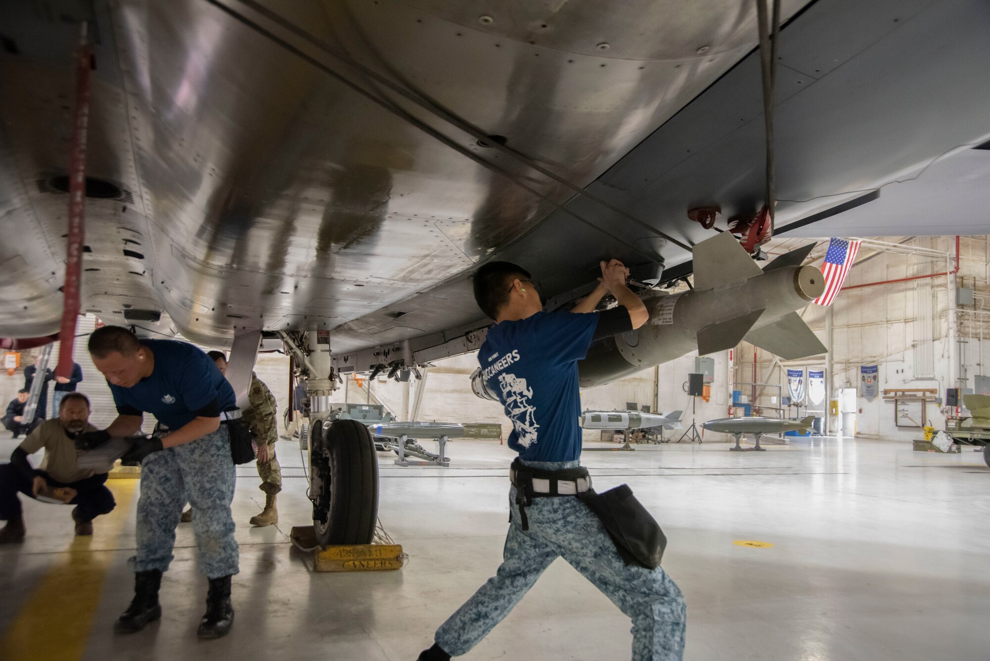 Republic of Singapore air force ME1 Nigel Goh, 428th Fighter Squadron load crew member, secures a guided bomb unit on the F-15SG Strike Eagle during the Annual Load Crew Competition, Feb. 25, 2020, at Mountain Home Air Force Base, Idaho. The objective of the Annual Load Crew Competition is to be the fastest three-man load crew to load ammunition on to the aircraft. (U.S. Air Force photo by Airman 1st Class Akeem K. Campbell)