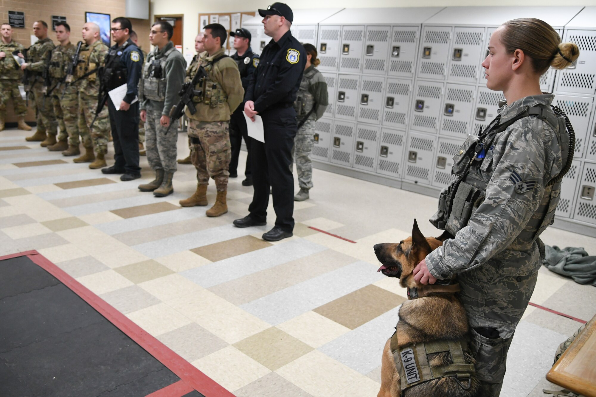 Joe, a military working dog assigned to the 75th Security Force Squadron at Hill Air Force Base, Utah, sits with his handler, Senior Airman Michelle Winters, March 4, 2020.  Winters has been Joe’s handler for about four months and she said their bond is starting to form. Joe is a single-purpose MWD, trained as an explosive detection dog. (U.S. Air Force photo by Cynthia Griggs)