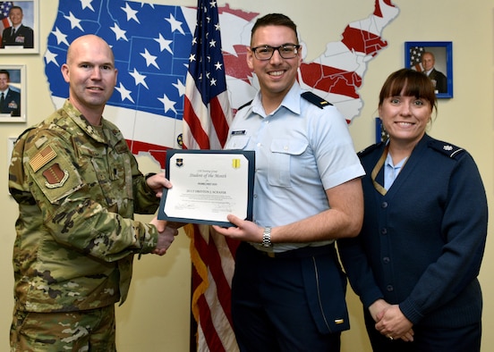 U.S. Air Force Lt. Col. Kevin Boss, 17th Training Group director of operations, presents the 315th Training Squadron Officer Student of the Month award to 2nd Lt. Dreyton Schafer, 315th TRS student, at Brandenburg Hall on Goodfellow Air Force Base, Texas, February 6, 2020. The 315th TRS’ vision is to develop combat-ready intelligence, surveillance and reconnaissance professionals and promote an innovative squadron culture and identity unmatched across the U.S. Air Force. (U.S. Air Force photo by Airman 1st Class Robyn Hunsinger)