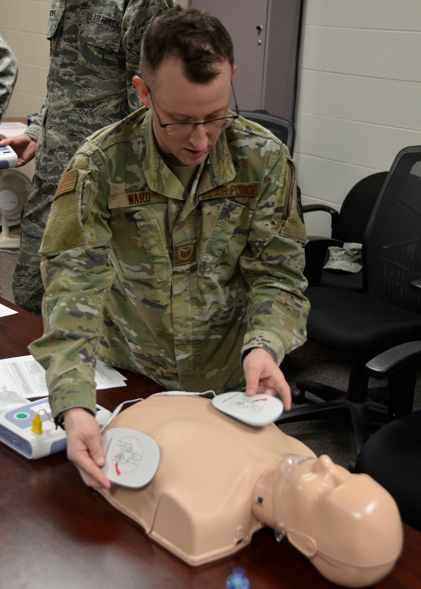Tech. Sgt. Michael Ward, a CPR trainer with the 445th Maintenance Squadron, demonstrates the proper placement of defibrillator pads as part of the 445th Maintenance Group mass training event held during the Feb. 8, 2020 unit training assembly. Ward is demonstrating how an automated external defibrillator is used in CPR to perform treatment until the arrival of emergency services. The CPR training was performed by both the 445th MXS and 445th Aircraft Maintenance Squadron. (U.S. Air Force photo/Staff Sgt. Ethan G. Spickler)