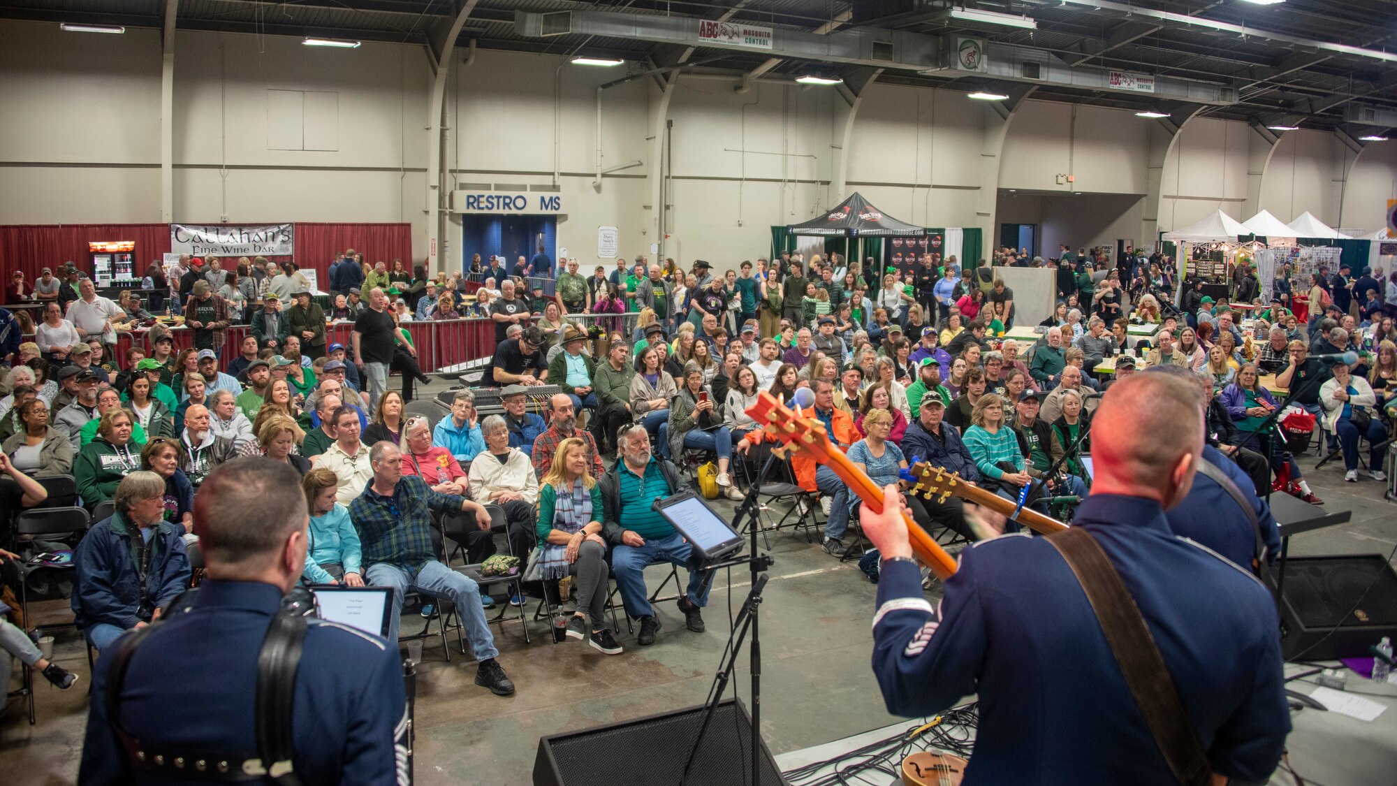 North Texas Irish Festival attendees watch a performance by Celtic Aire, U.S. Air Force Band premier Celtic and folk ensemble, during the North Texas Irish Festival in Dallas, Tx., March 7, 2020. The band performed four times during the weekend during they performed traditional Celtic folk songs, Irish reels and jigs, pub songs, and even cover versions of pop songs. (U.S. Air Force photo by Staff Sgt. Jared Duhon)