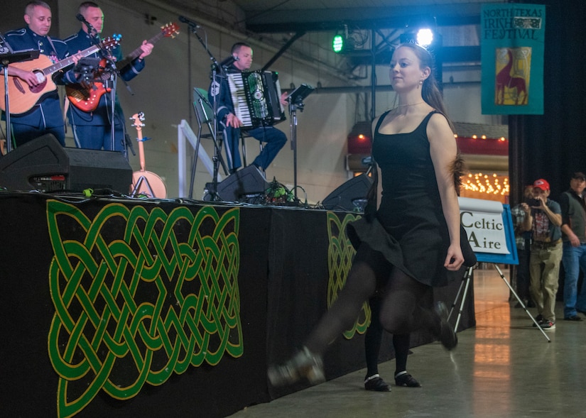 A Dancer from the Shandon O'Regan dance academy dances during a performance by U.S. Air Force Band ensemble Celtic Aire during the 38th Annual North Texas Irish Festival in Dallas, Tx., March 7, 2020. The North Texas Irish Festival boasted 13 different stages of chefs, dancers, mixologists, storytellers and musicians from around the world showcasing Celtic heritage. (U.S. Air Force photo by Staff Sgt. Jared Duhon)