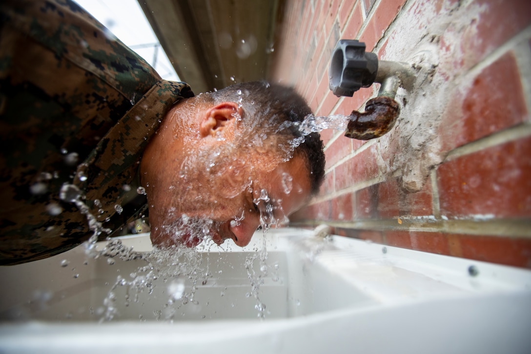 A Marine attached to Deployment Processing Command Reserve Support Unit-East, Force Headquarters Group, runs water of his face after gas chamber training at Marine Corps Base Camp Lejeune, North Carolina, Oct. 22, 2019. The DPC/RSU-East staff provide activated Reserve units/dets various types of training such as gas chamber qualification. During the qualification, Marines are taught chemical, biological, radiological and nuclear threats, reactions to CBRN attacks, and how to take proper care and use of a gas mask. (U.S. Marine Corps photo by Sgt. Andy O. Martinez)