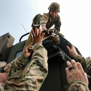 Spc. Walter Schrock, a multiple launch rocket system crewmember assigned to 1st Battalion, 14th Field Artillery Regiment, 75th Field Artillery Brigade, Fort Sill, Oklahoma, waits beside his M240B machine gun while mounted on an M142 High Mobility Artillery Rocket System (HIMARS) at Kerr Hill range, Fort Sill, June 4, 2019. (U.S. Army photo by Sgt. Dustin D. Biven / 75th Field Artillery Brigade)