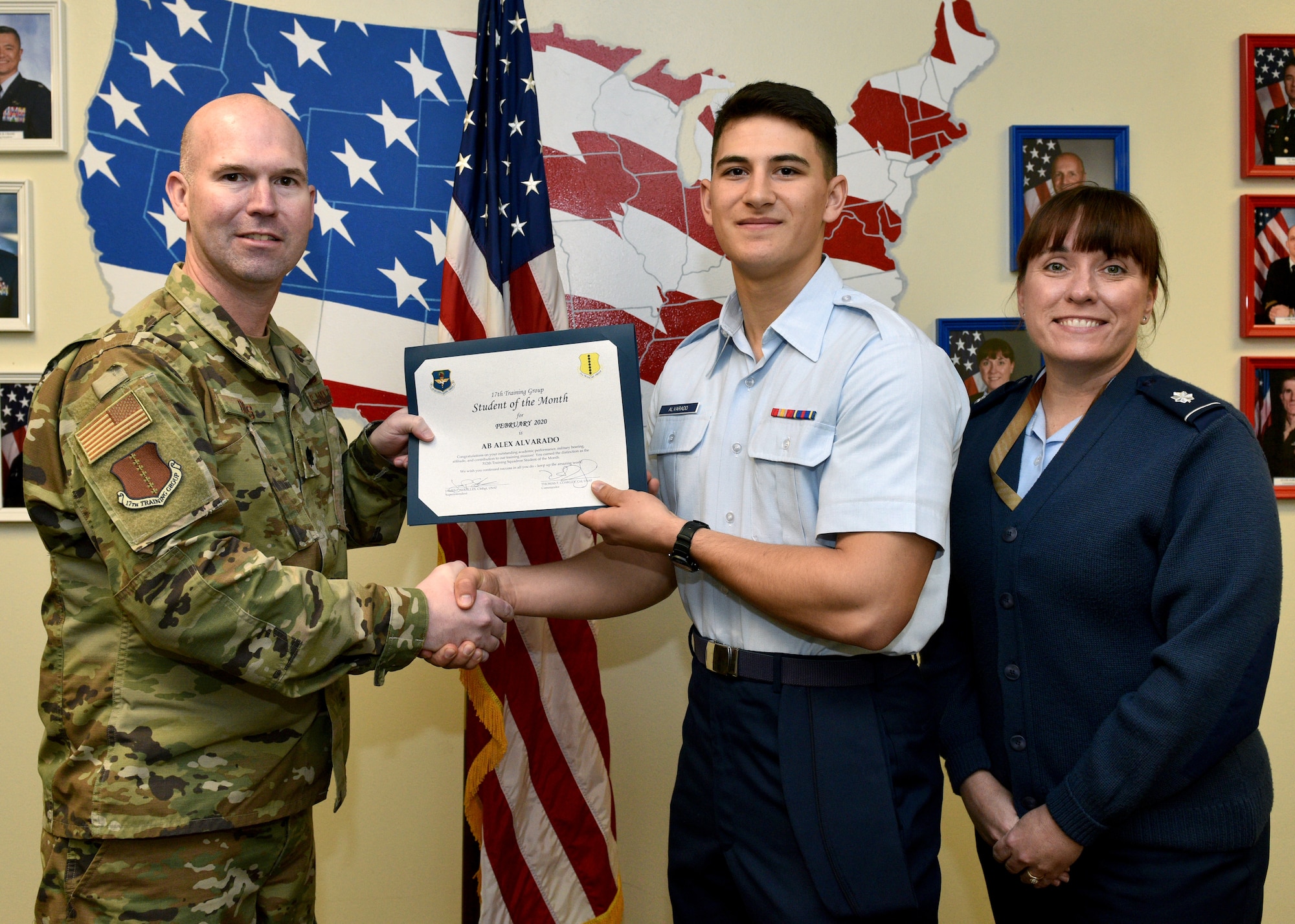U.S. Air Force Lt. Col. Kevin Boss, 17th Training Group director of operations, presents the 312th Training Squadron Student of the Month award to Airman Alex Alvarado, 312th TRS student, at Brandenburg Hall on Goodfellow Air Force Base, Texas, February 6, 2020. The 312th TRS’ mission is to provide Department of Defense and international allies with mission ready fire protection and special instruments graduates and provide mission support for the Air Force Technical Applications Center. (U.S. Air Force photo by Airman 1st Class Robyn Hunsinger)