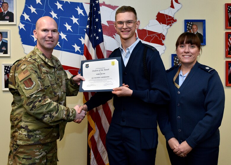 U.S. Air Force Lt. Col. Kevin Boss, 17th Training Group director of operations, presents the 315th Training Squadron Student of the Month award to Airman 1st Class Mathieu Sherburne, 315th TRS student, at Brandenburg Hall on Goodfellow Air Force Base, Texas, February 6, 2020. The 315th TRS’ vision is to develop combat-ready intelligence, surveillance and reconnaissance professionals and promote an innovative squadron culture and identity unmatched across the U.S. Air Force. (U.S. Air Force photo by Airman 1st Class Robyn Hunsinger)