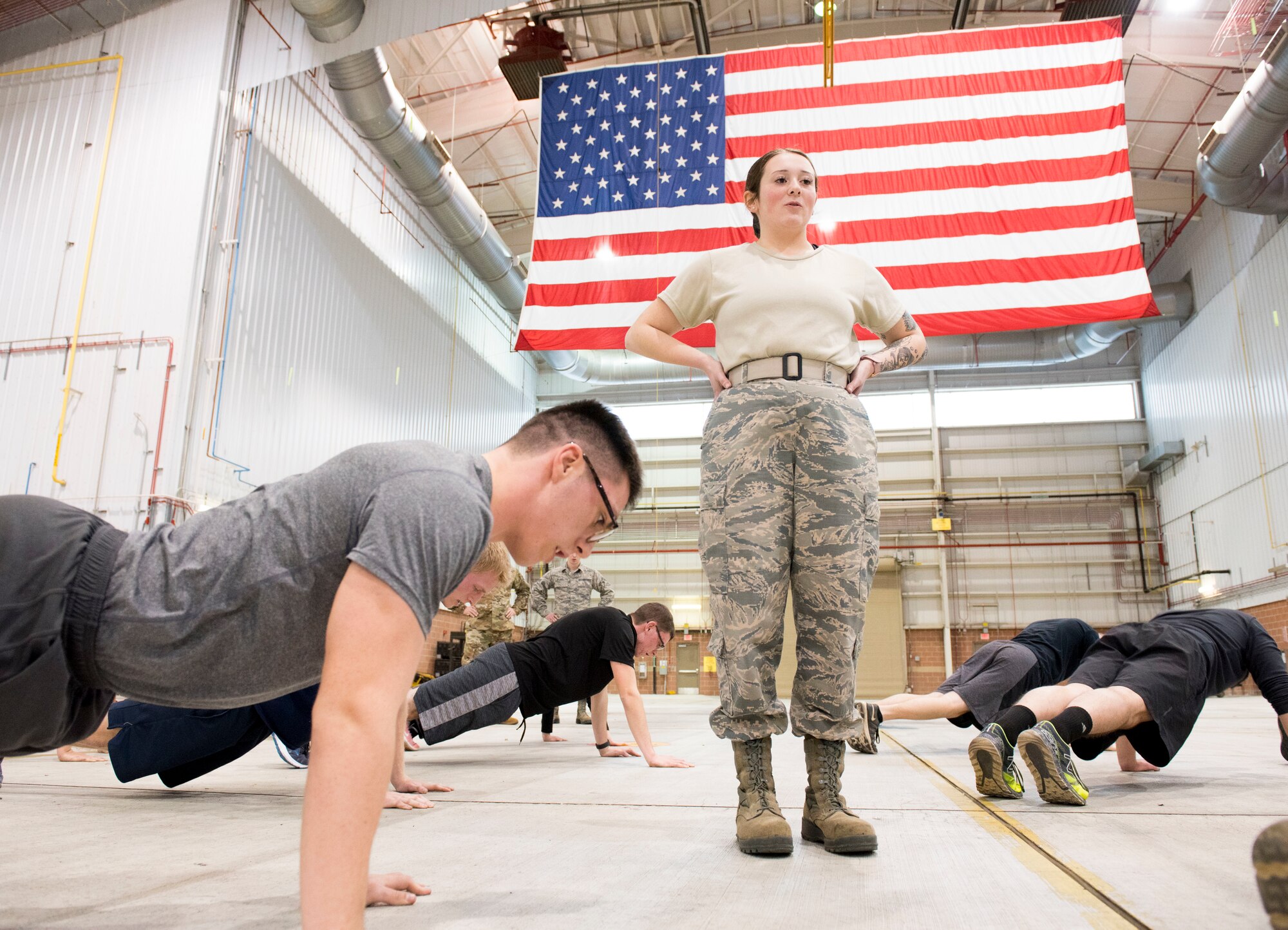 Airman 1st Class Julianne Arnold, counts reps during a physical fitness session for the Airmen in the 167th Airlift Wing's student flight program, Feb. 1, 2020. The student flight program prepares the wing's newest Airmen for U.S. Air Force basic training.