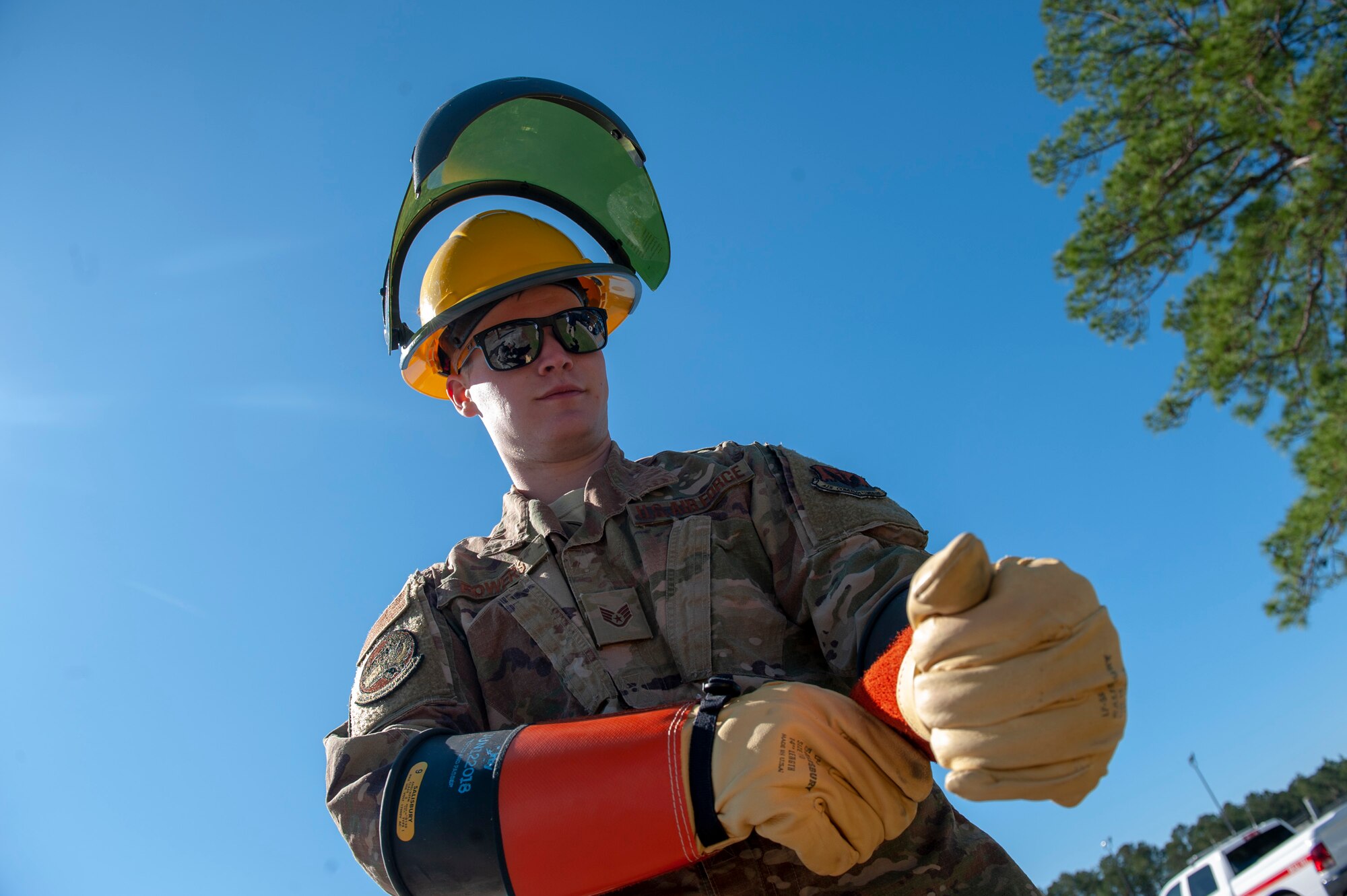 A photo of an Airman putting on gloves.