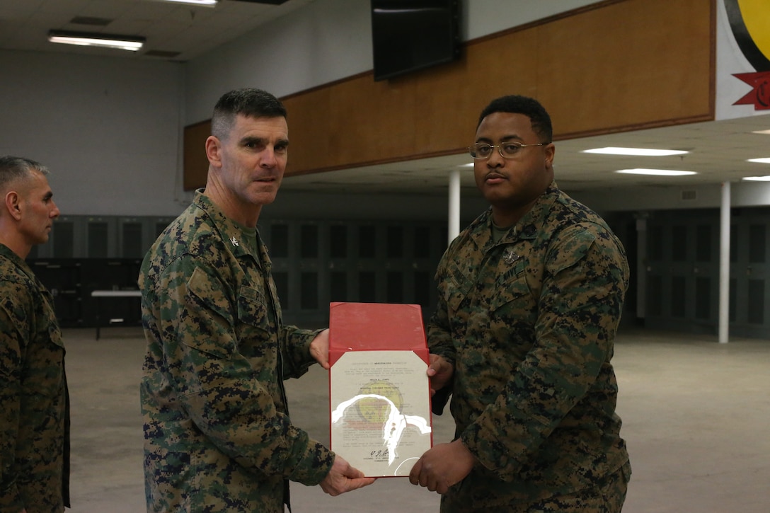 U.S. Marine Col. Donald J. Riley Jr., Commanding Officer for Chemical Biological Incident Response Force (CBIRF), poses with Petty Officer 3rd Class Malik Jones, a corpsman with CBIRF aboard Naval Support Facility Indian Head, Md., on March 4th, 2020. Petty Officer 3rd Class Jones was meritoriously promoted because he has proven himself to be above his peers. (Official U.S. Marine Corps photo by Lance Cpl. Blakely Graham/released)
