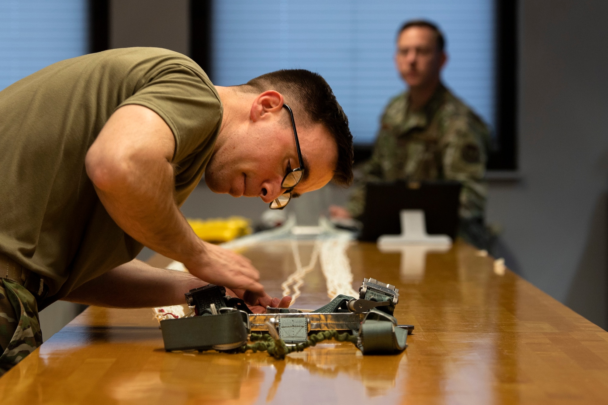 U.S. Air Force Tech. Sgt. Matthew Lydick, 52nd Operations Support Squadron Aircrew Flight Equipment main-shop NCO in charge, left, and Staff Sgt. Jacob Wade, 52nd OSS AFE main-shop assistant NCO in charge, right, pack a parachute at Spangdahlem Air Base, Germany, March 4, 2020. In October 2019, an F-16 Fighting Falcon from the 52nd Fighter Wing crashed due to a partial power loss. Lydick packed the parachute that saved the pilot's life. (U.S. Air Force photo by Senior Airman Valerie R. Seelye)