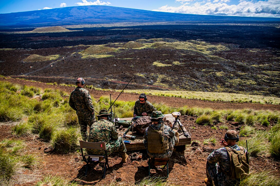 U.S. Marines with 3rd Marine Regiment and 1st Battalion, 12th Marine Regiment, communicate with aircraft during a tactical air control party at Pohakuloa Training Area, Hawaii, Feb. 26, 2020. Joint Terminal Attack Controllers conducted the exercise in order to better coordinate air support assets and calls for fire. (U.S. Marine Corps photo by Lance Cpl. Jacob Wilson)
