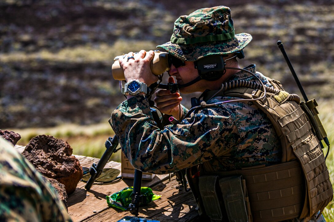 A U.S. Marine with 3rd Marine Regiment, 3rd Marine Division, locates his target downrange during a tactical air control party at Pohakuloa Training Area, Hawaii, Feb. 26, 2020. Joint terminal attack controllers conducted the exercise in order to better coordinate air support assets and calls for fire. (U.S. Marine Corps photo by Lance Cpl. Jacob Wilson)