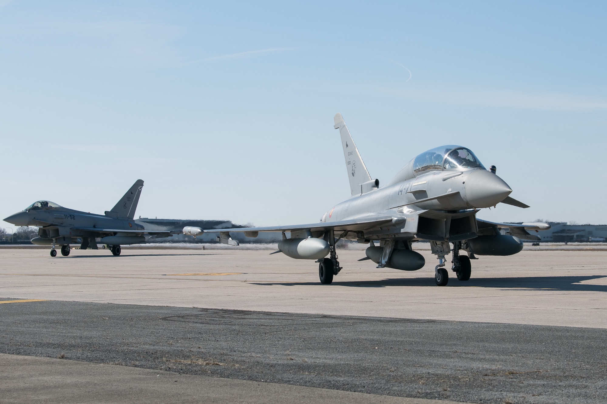 Spanish Eurofighter Typhoons taxi into a parking spot after landing, March 1, 2020, at Dover Air Force Base, Delaware. The aircraft and crew stopped at Dover AFB on their way to Nellis AFB, Nevada for Exercise Red Flag 20-2, a multi-national, air-to-air combat training exercise. (U.S. Air Force photo by Mauricio Campino)