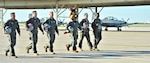 The Spurs Coyote and his mission teammates for the day walk to their planes at Joint Base San Antonio-Randolph, Texas February 25 where Regular Air Force, Air Force Reserve, and civilian Airmen from the 340th Flying Training Group headquarters, 39th Flying Training Squadron T-6 Texan Flight, 12th Flying Training Wing Safety, 559th Flying Training Squadron T-6 team, and 3rd Combat Camera Squadron (JBSA-Lackland) members, and the NBA San Antonio Spurs production crew worked to put the Coyote through the pilot training process. Video footage will be used for a Spurs Military Appreciation video to be shown during the March 10 game. (U.S. Air Force photo by Debbie Gildea)