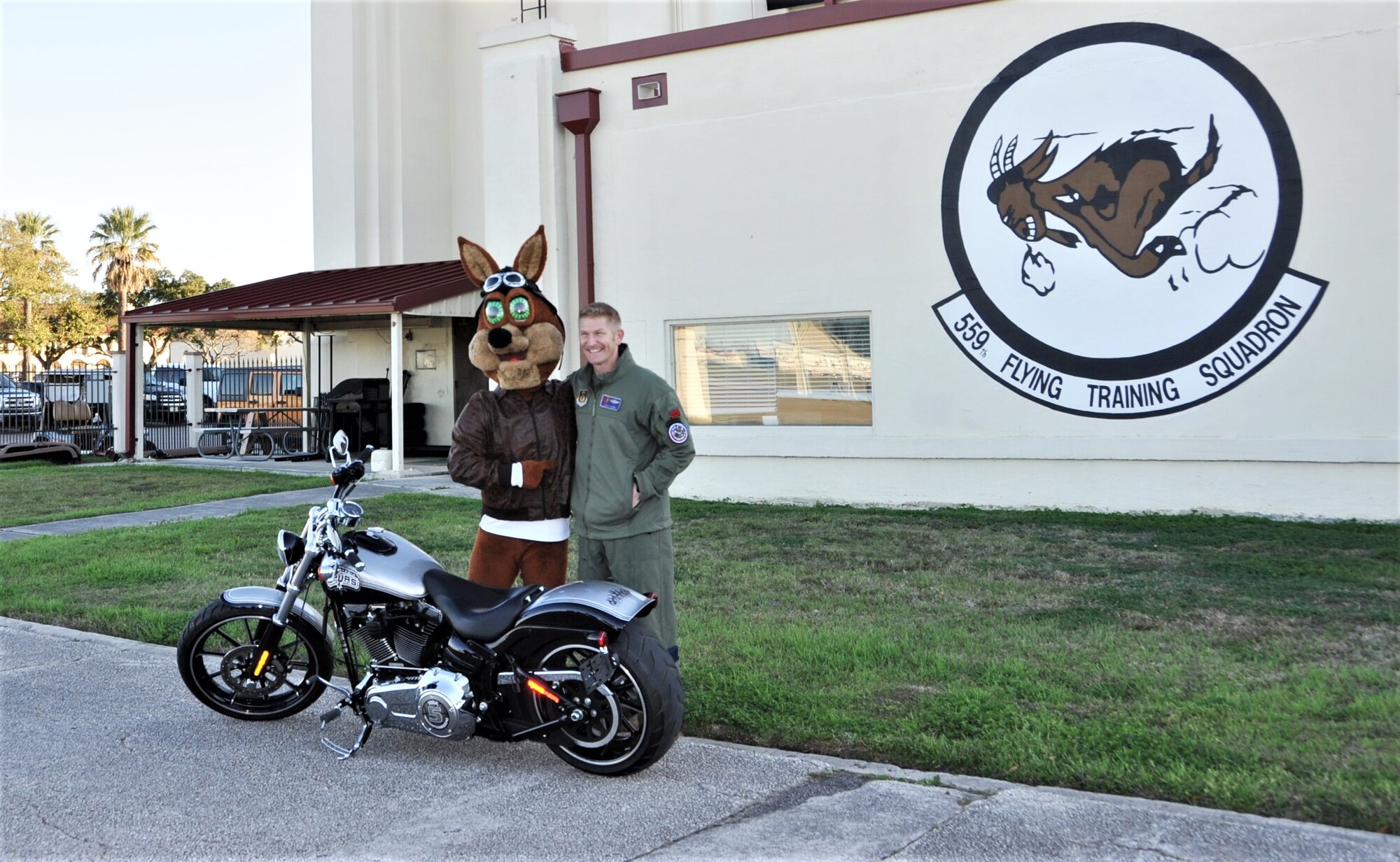 The Spurs Coyote pauses for a photo with his friend from the 340th Flying Training Group – Lt. Col. Mark Pasierb – on the Joint Base San Antonio-Randolph, Texas flight line February 25 where Regular Air Force, Air Force Reserve, and civilian Airmen from the 340th Flying Training Group headquarters, 39th Flying Training Squadron T-6 Texan Flight, 12th Flying Training Wing Safety, 559th Flying Training Squadron T-6 team, and 3rd Combat Camera Squadron (JBSA-Lackland) members, and the NBA San Antonio Spurs production crew worked to put the Coyote through the pilot training process. Video footage will be used for a Spurs Military Appreciation video to be shown during the March 10 game.  (U.S. Air Force photo by Janis El Shabazz)