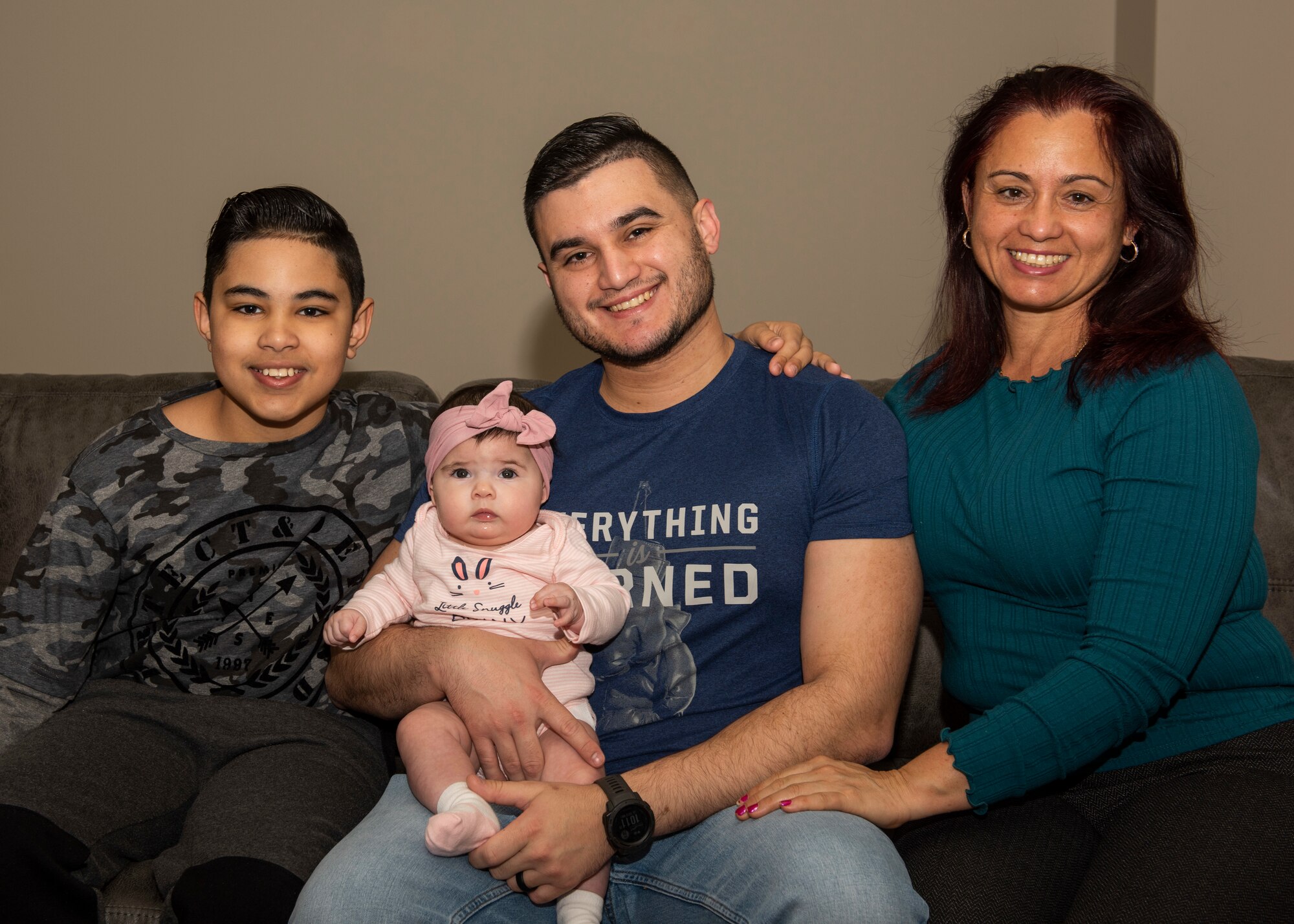 U.S. Air Force Staff Sgt. Ramses Alfonso, 673d Security Forces Squadron lead patrolman, holds his daughter and poses for a photo with his mother and younger brother in Anchorage, Alaska, Dec. 20, 2019. When Alfonso was in fifth grade, he immigrated to the United States from Cuba and learned English. Alfonso graduated from Anchorage Police Department 19-1 Academy and earned the Distinguished Honor Graduate Award, Class Valedictorian, Top Shooter, and Top Defensive Driver in the Emergency Vehicle Operations Course.