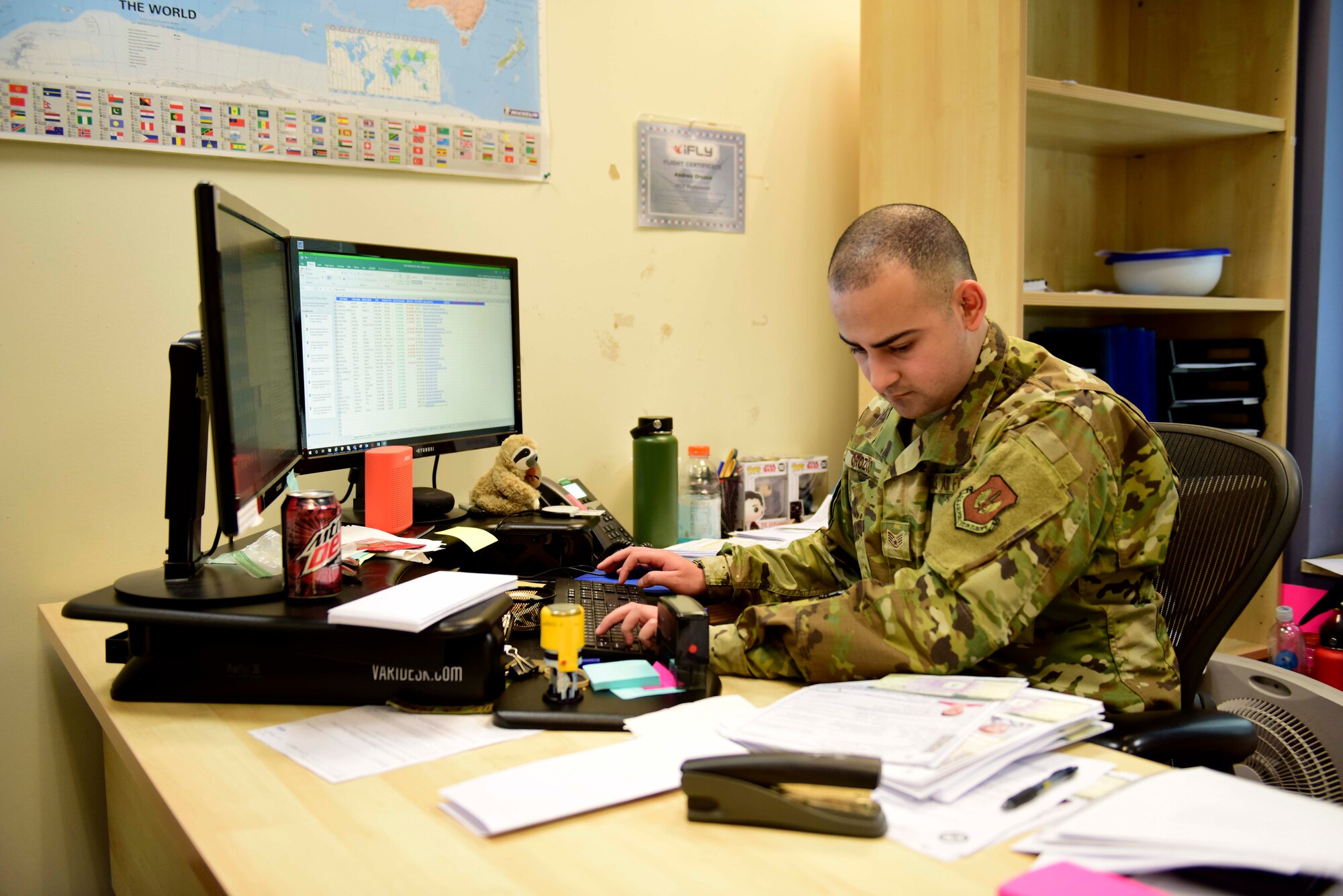 Staff Sgt. Andres Orozco, 31st Force Support Squadron noncommissioned officer in charge of the Passport Office, enters data while processing a passport request on Aviano Air Base, Italy, Feb. 27, 2020. Orozco is part of a two-person team responsible for processing passports for the 31st Fighter Wing. (U.S. Air Force photo by Tech. Sgt. Tory Cusimano)