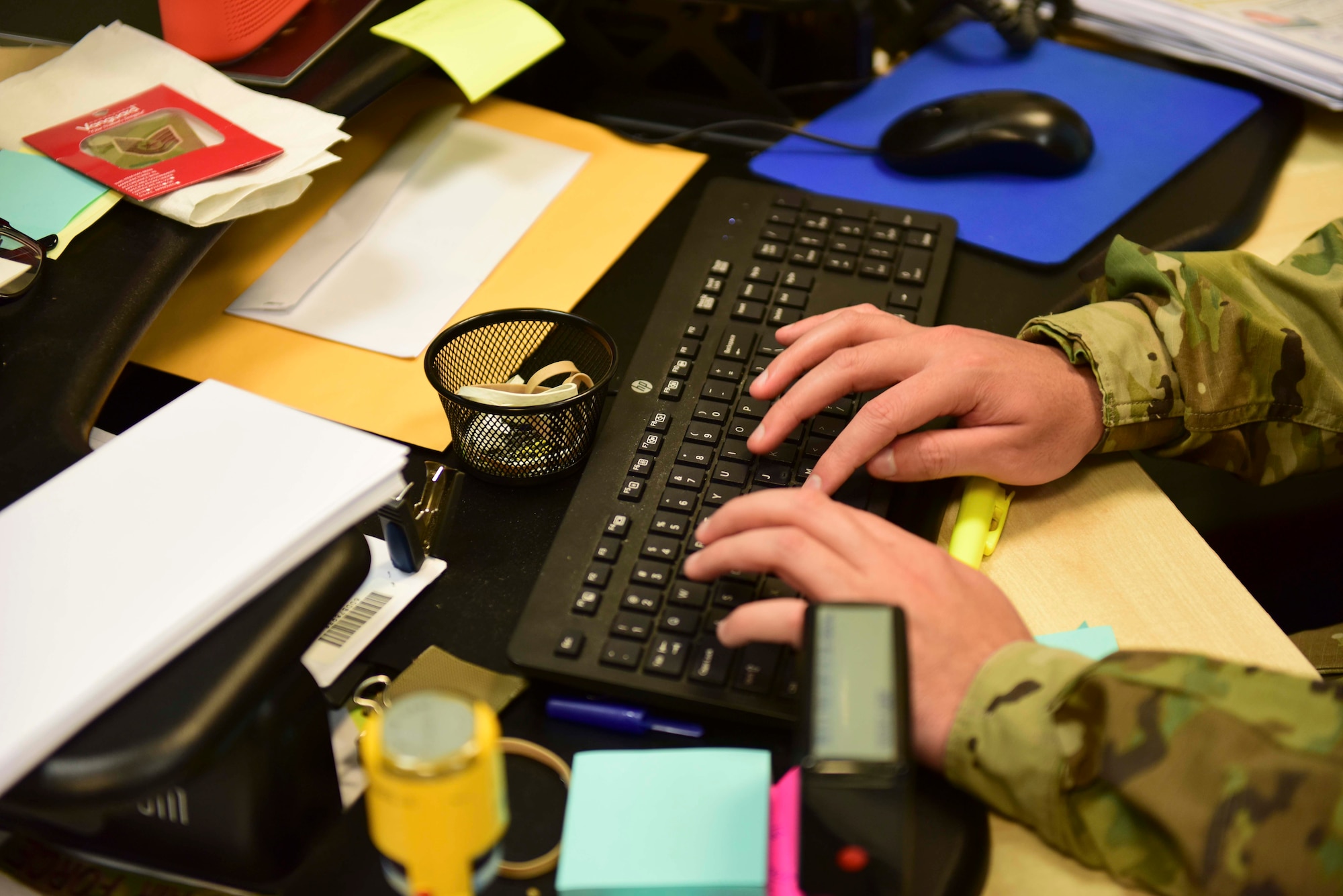 Staff Sgt. Andres Orozco, 31st Force Support Squadron noncommissioned officer in charge of the Passport Office, types information on a keyboard at Aviano Air Base, Italy, Feb. 27, 2020. Some types of passports can take one to three months to process. (U.S. Air Force photo by Tech. Sgt. Tory Cusimano)