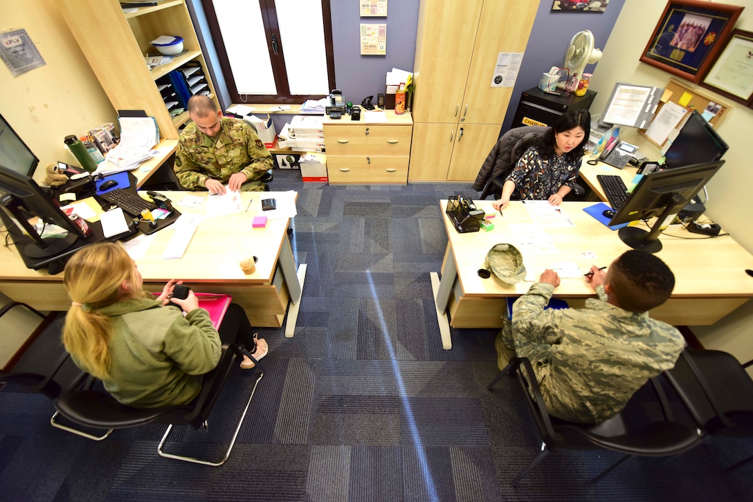 Passport Office members process paperwork at Aviano Air Base, Italy, Feb. 27, 2020. The Passport Office processes tourist, passport, diplomatic, and no-fee passports. (U.S. Air Force photo by Tech. Sgt. Tory Cusimano)