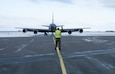 Airmen taxiing military refueling aircraft.