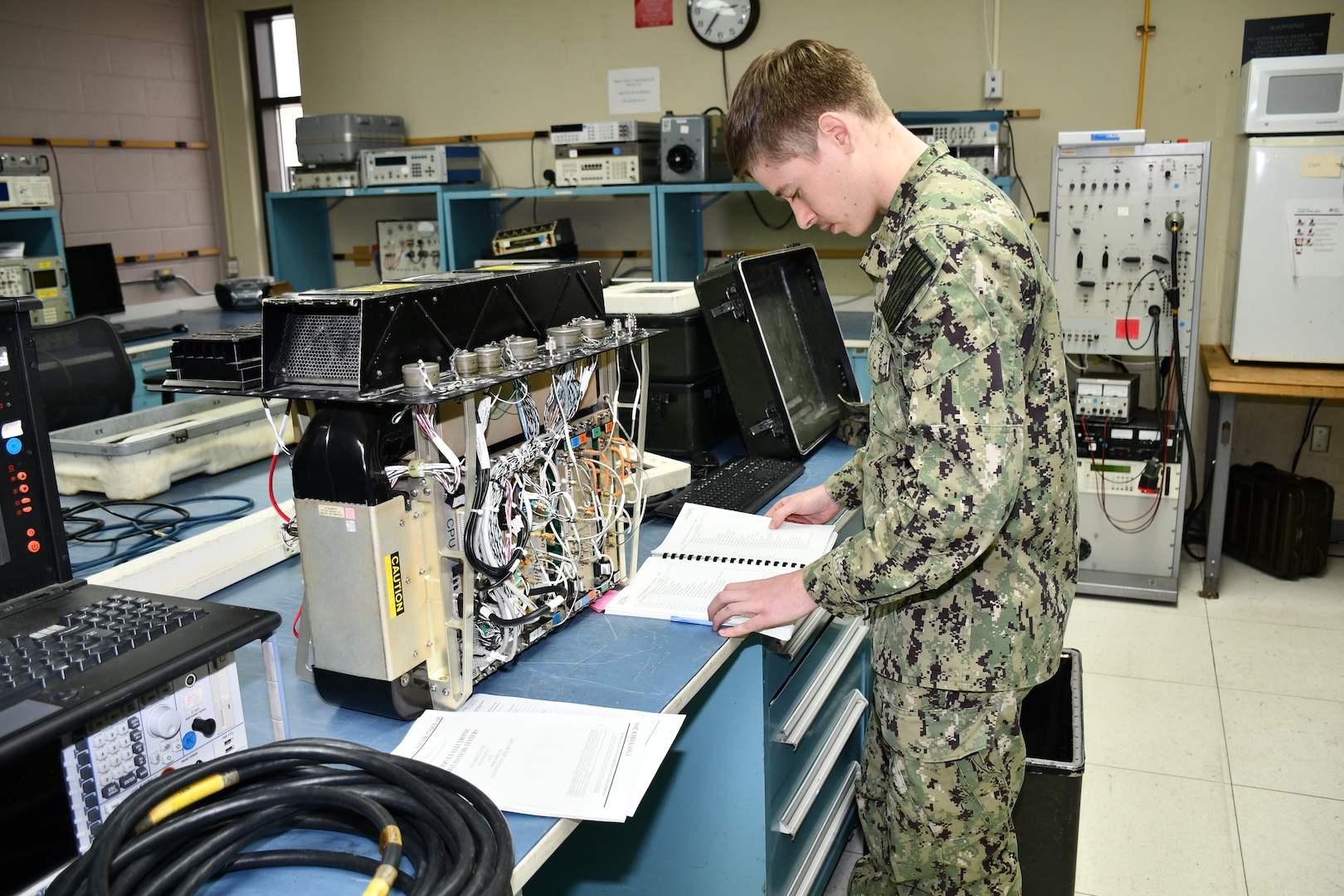Electronics Technician Second Class Samuel Walling, Calibration Technician for the Mid-Atlantic Regional Calibration Center, troubleshoots and repairs a Navigation Communication Test Set for Fleet Logistics Support Squadron 40 (VFA-40) “Rawhides” in direct support of flight line readiness.