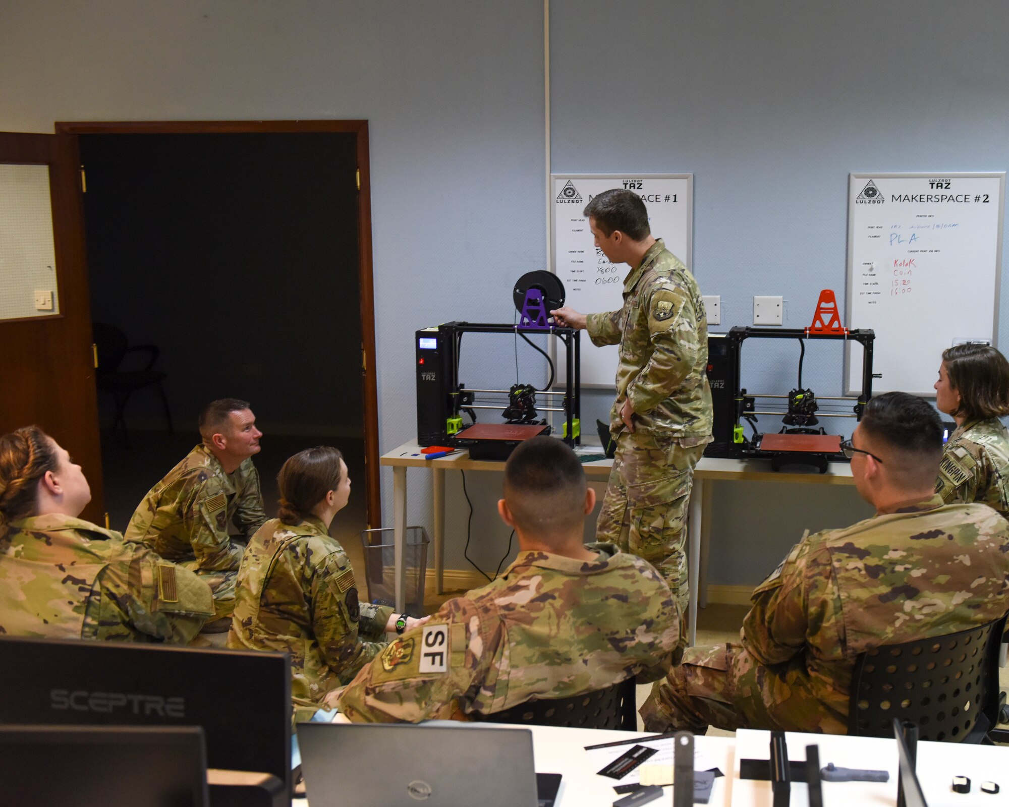 U.S. Air Force Airmen deployed to U.S. Air Forces Central Command sit through a 3D printer presentation during the U.S. Air Forces Central Command Innovation Summit in the 379th Air Expeditionary Wing’s Desert Spark Lab at Al Udeid Air Base, Qatar, March 3, 2020.