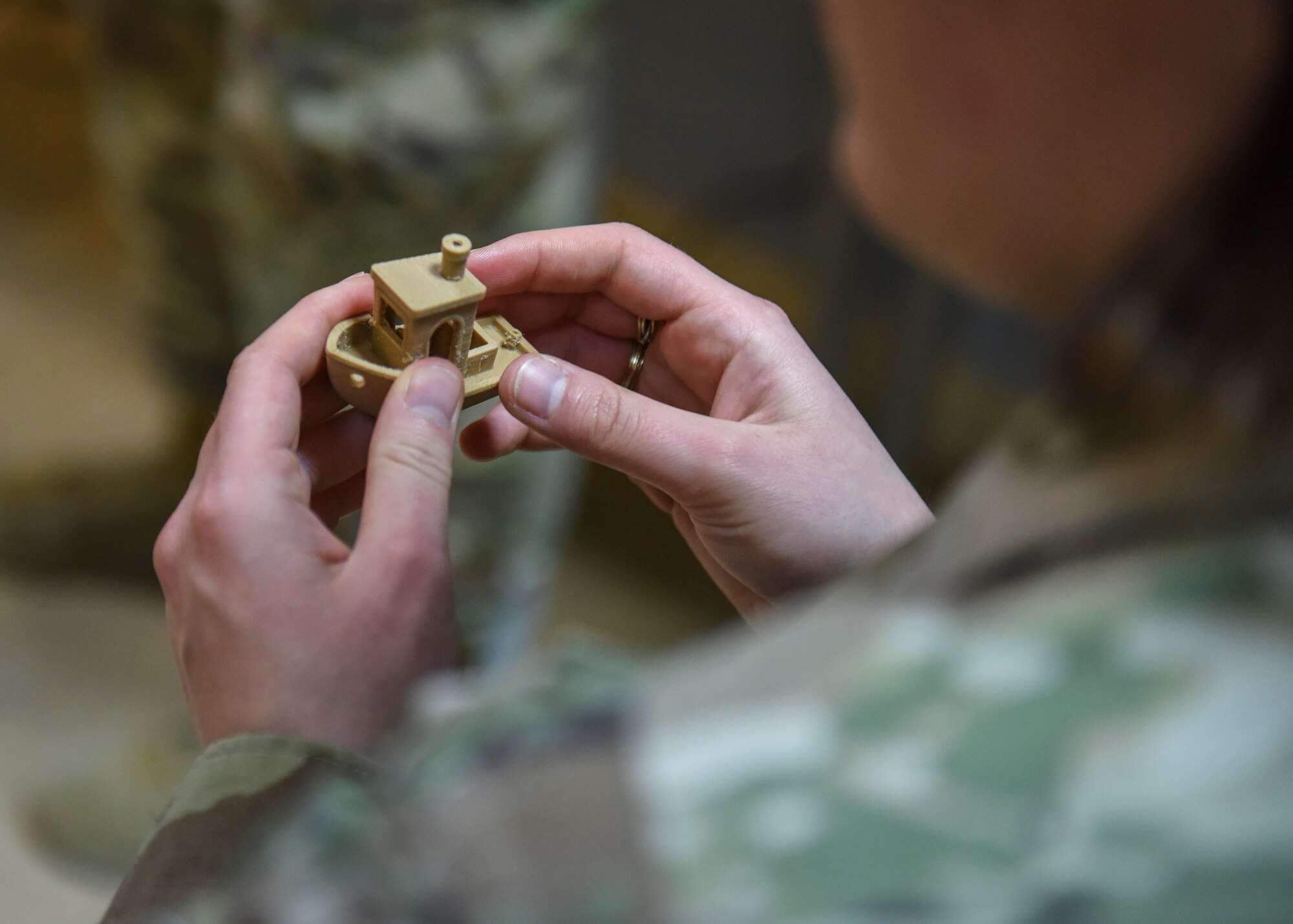 U.S. Air Force Capt. Claire Hoover, an air battle manager assigned to the 380th Air Expeditionary Wing, deployed to Al Dhafra Air Base, United Arab Emirates, holds a 3D printed boat during the U.S. Air Forces Central Command Innovation Summit in the 379th Air Expeditionary Wing’s Desert Spark Lab at Al Udeid Air Base, Qatar, March 3, 2020.