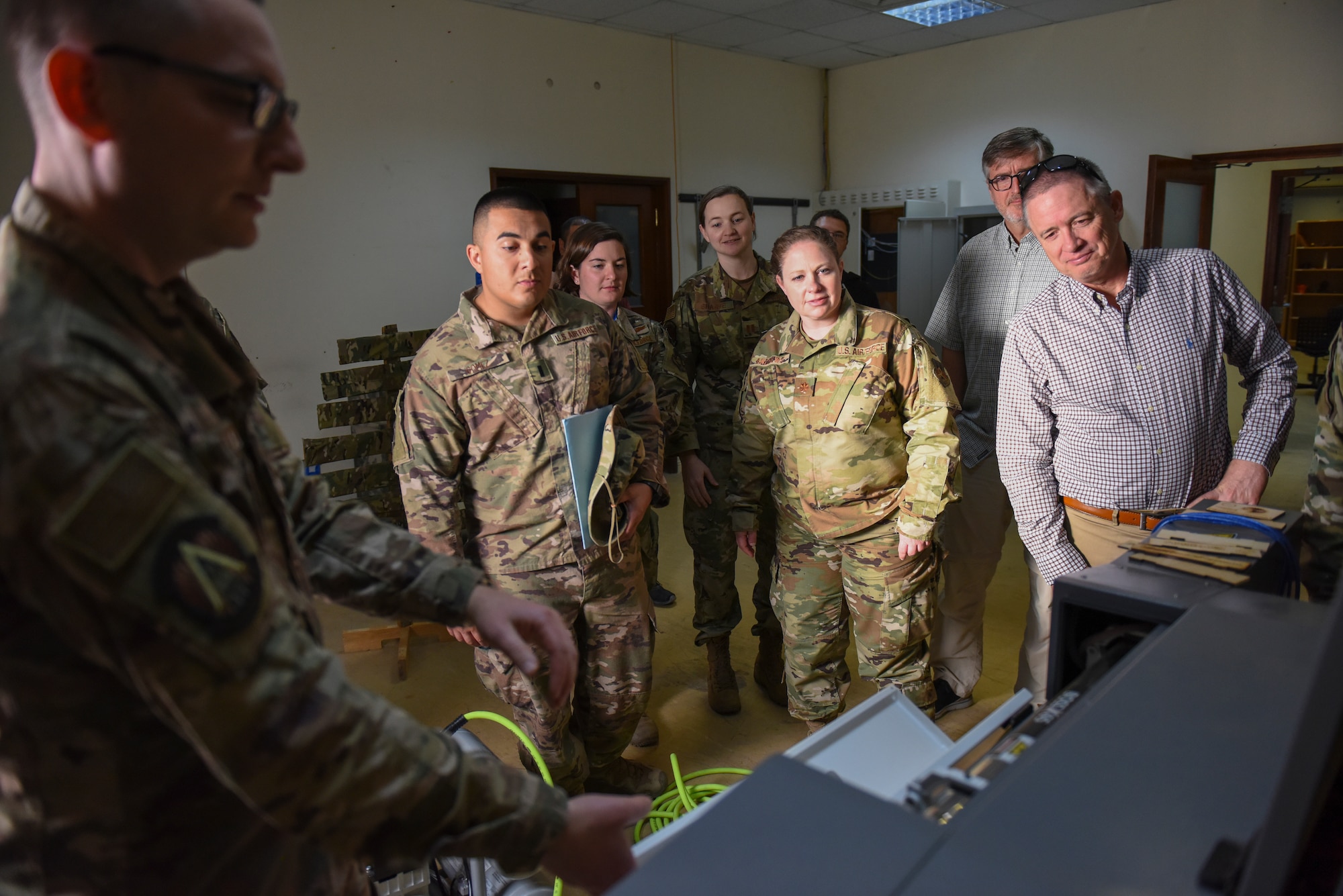 U.S. Air Force Maj. Kyle Boothe, U.S. Air Forces Central Command chief innovation officer, shows a laser cutter during the AFCENT Innovation Summit in the 379th Air Expeditionary Wing’s Desert Spark Lab at Al Udeid Air Base, Qatar, March 3, 2020.