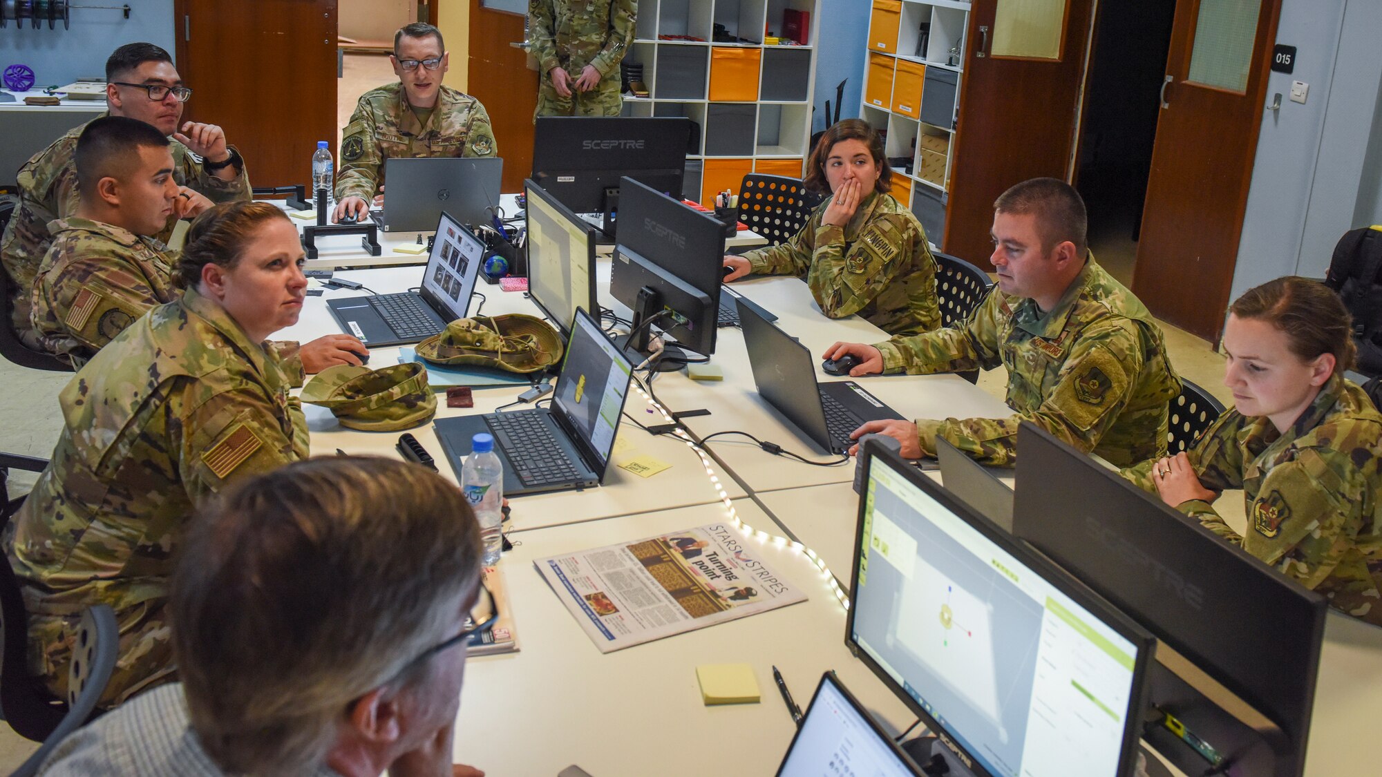 U.S. Air Force Airmen assigned to U.S. Air Forces Central Command sit through a 3D printer presentation during the U.S. Air Forces Central Command Innovation Summit in the 379th Air Expeditionary Wing’s Spark Tank Desert Lab at Al Udeid Air Base, Qatar, March 3, 2020.