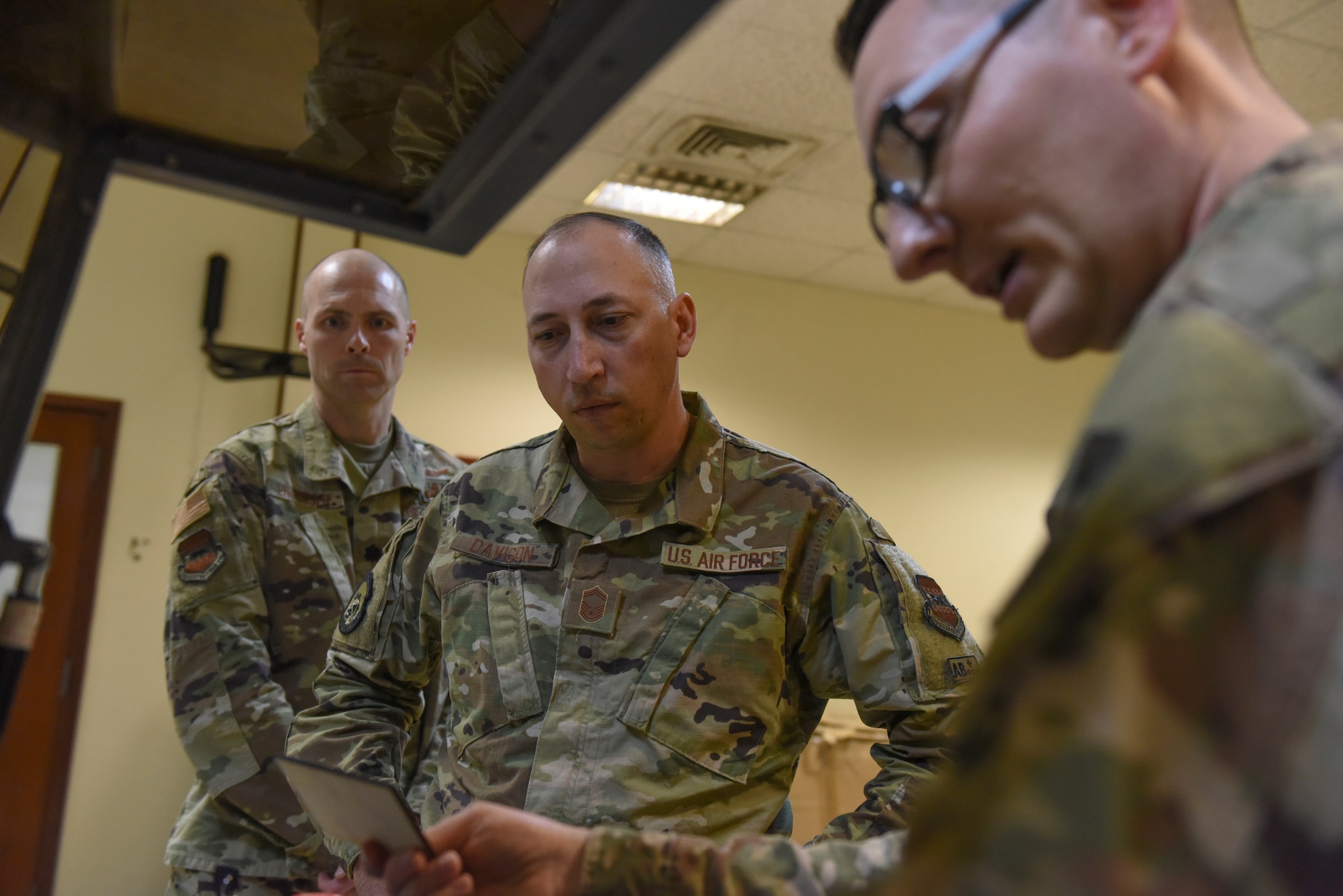 U.S. Air Force Airmen assigned to U.S. Air Forces Central Command view a piece of wood that has been etched by a laser printer during the U.S. Air Forces Central Command Innovation Summit in the 379th Air Expeditionary Wing’s Desert Spark Lab at Al Udeid Air Base, Qatar, March 4, 2020.