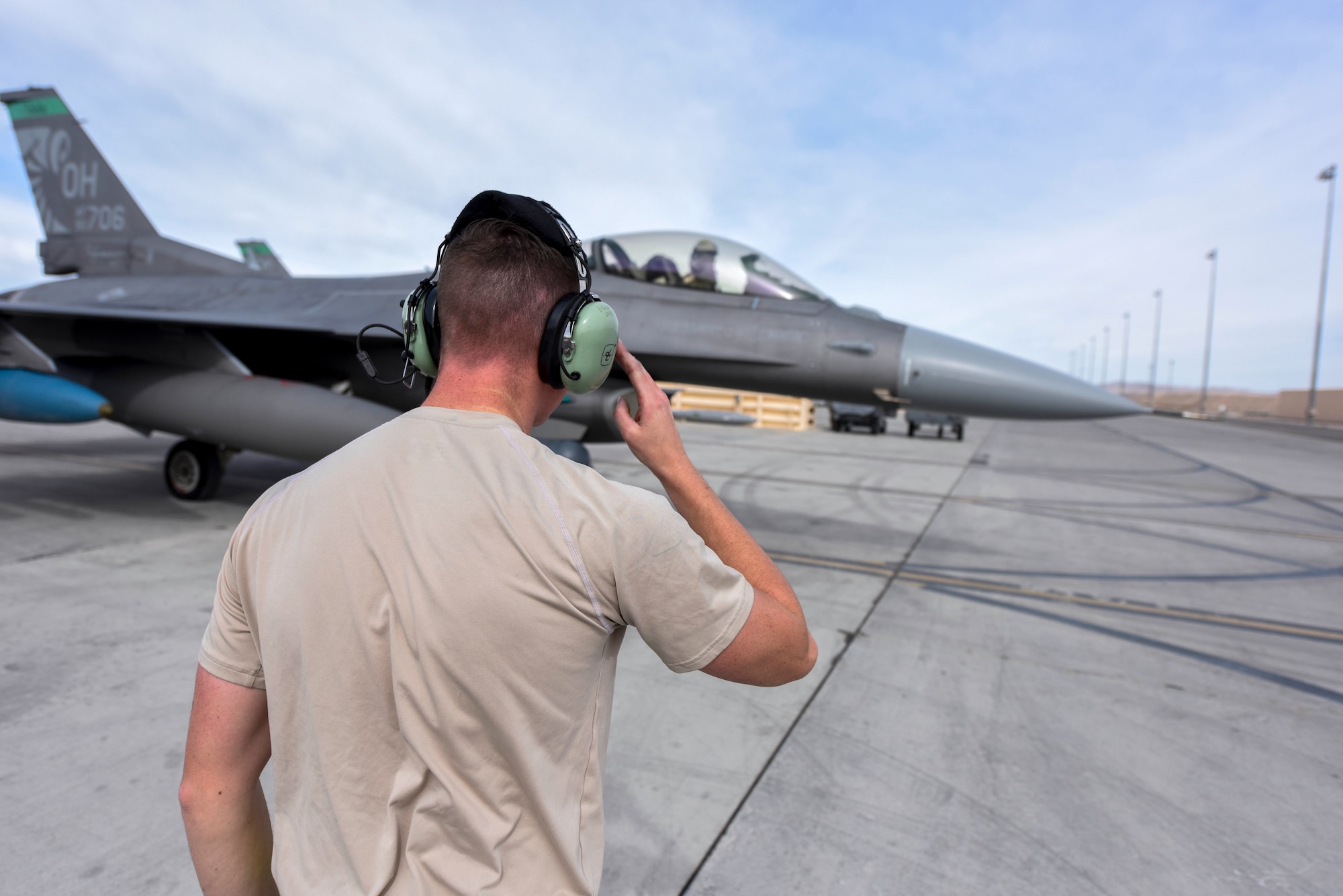 U.S. Air Force Staff Sgt. Brayden Bobp, a crew chief assigned to the Ohio National Guard’s 180th Fighter Wing, salutes a pilot assigned to the 180FW as he taxis to the runway at Nellis Air Force Base, Nevada during exercise Green Flag-West, Feb. 15, 2020. Green Flag is a realistic, air-to-surface, joint training exercise designed to improve interoperability between aircraft and ground troops. (U.S. Air National Guard photo by Senior Airman Kregg York)