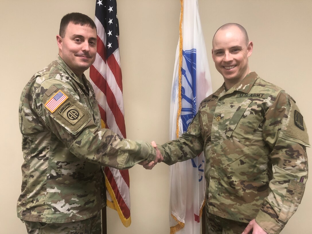 U.S. Army Reserve Maj. Brenden Glynn, recently promoted, and a cyber qualified officer currently assigned to the Northeast Cyber Protection Center, U.S. Army Reserve Cyber Protection Brigade, 335th Signal Command (Theater), is congratulated by Lt. Col. Christopher Rowey, former operations officer for Northeast, January 28