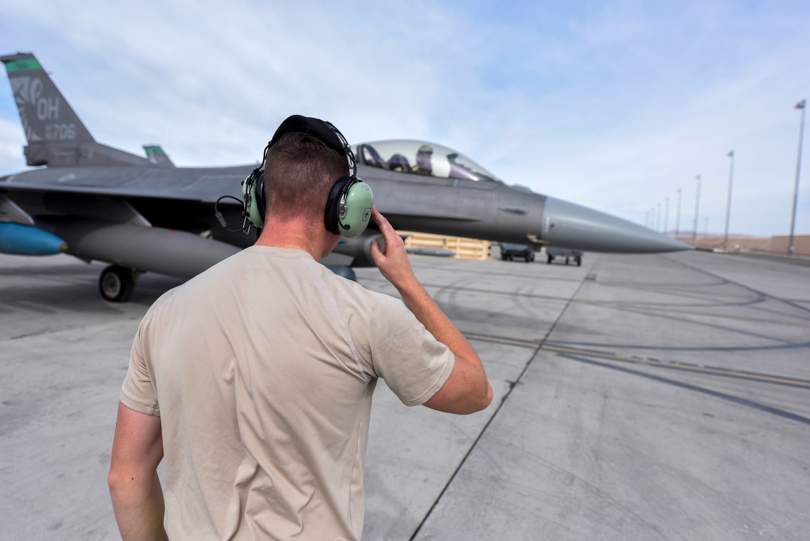 U.S. Air Force Staff Sgt. Brayden Bobp, a crew chief assigned to the Ohio National Guard’s 180th Fighter Wing, salutes a 180FW pilot at Nellis Air Force Base, Nevada, during exercise Green Flag-West, Feb. 15, 2020. The joint training exercise improves interoperability between aircraft while supporting ground troops by allowing U.S. military branches and other NATO and allied nations to work together.
