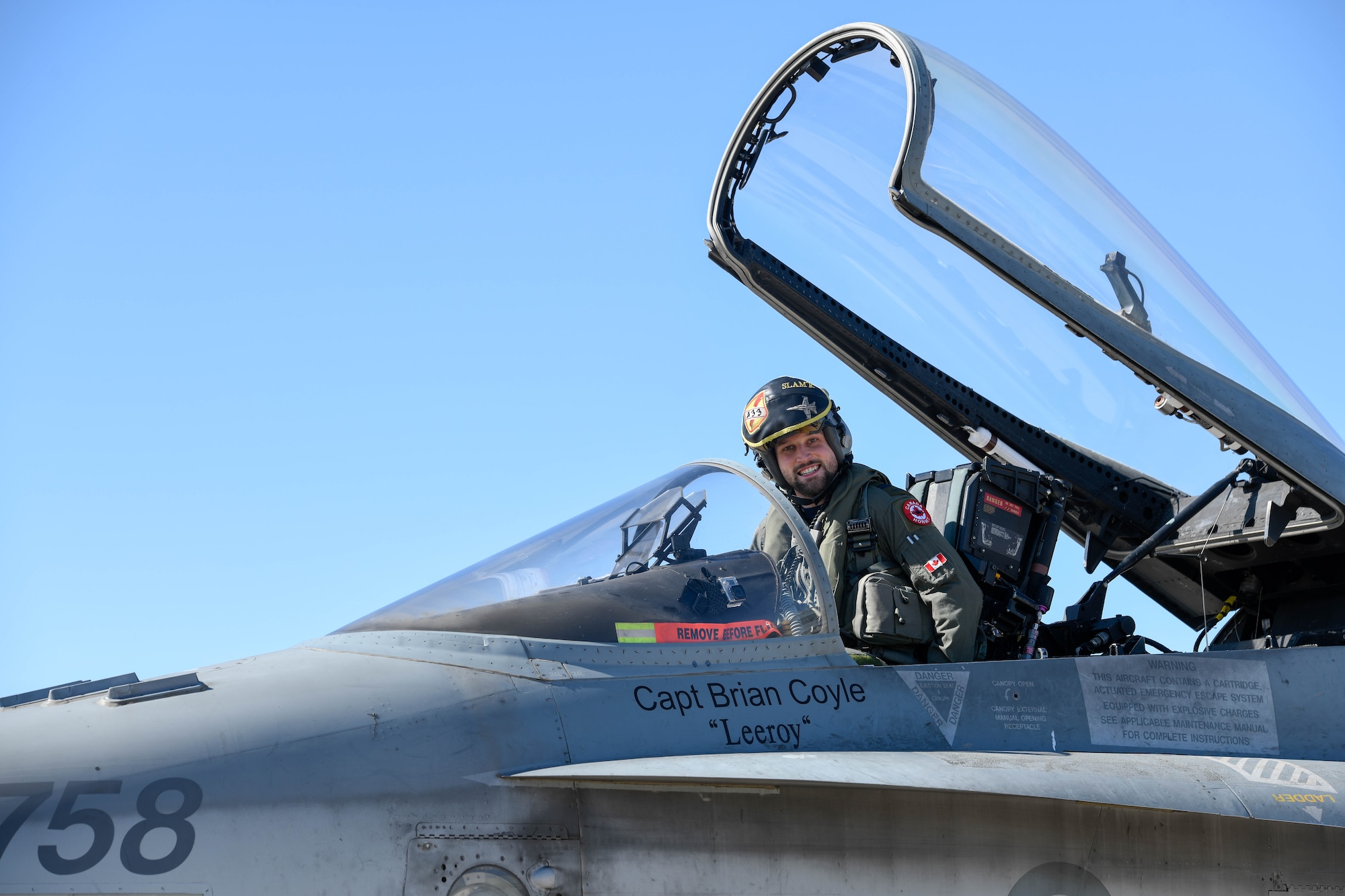 A Royal Canadian air force CF-18 Hornet pilot, assigned to the 433rd Tactical Fighter Squadron in Canadian Forces Base Bagotville, Quebec, Canada, poses for a photo Feb. 25, 2020, at Luke Air Force Base, Ariz.