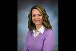 official photo lady in purple shirt against a blue background