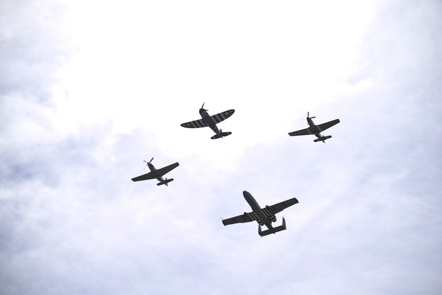 A photo of vintage and modern aircraft flying together in formation.