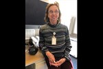 Sandy Powers leaning against her desk